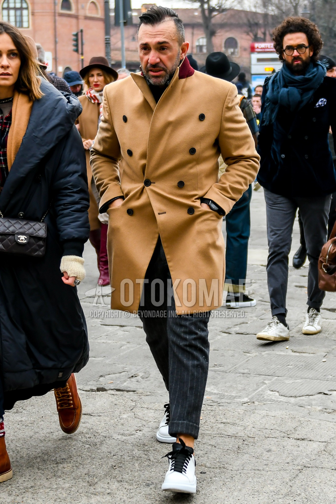 Men's winter outfit with brown plain chester coat, dark gray stripes slacks, white low-cut sneakers.