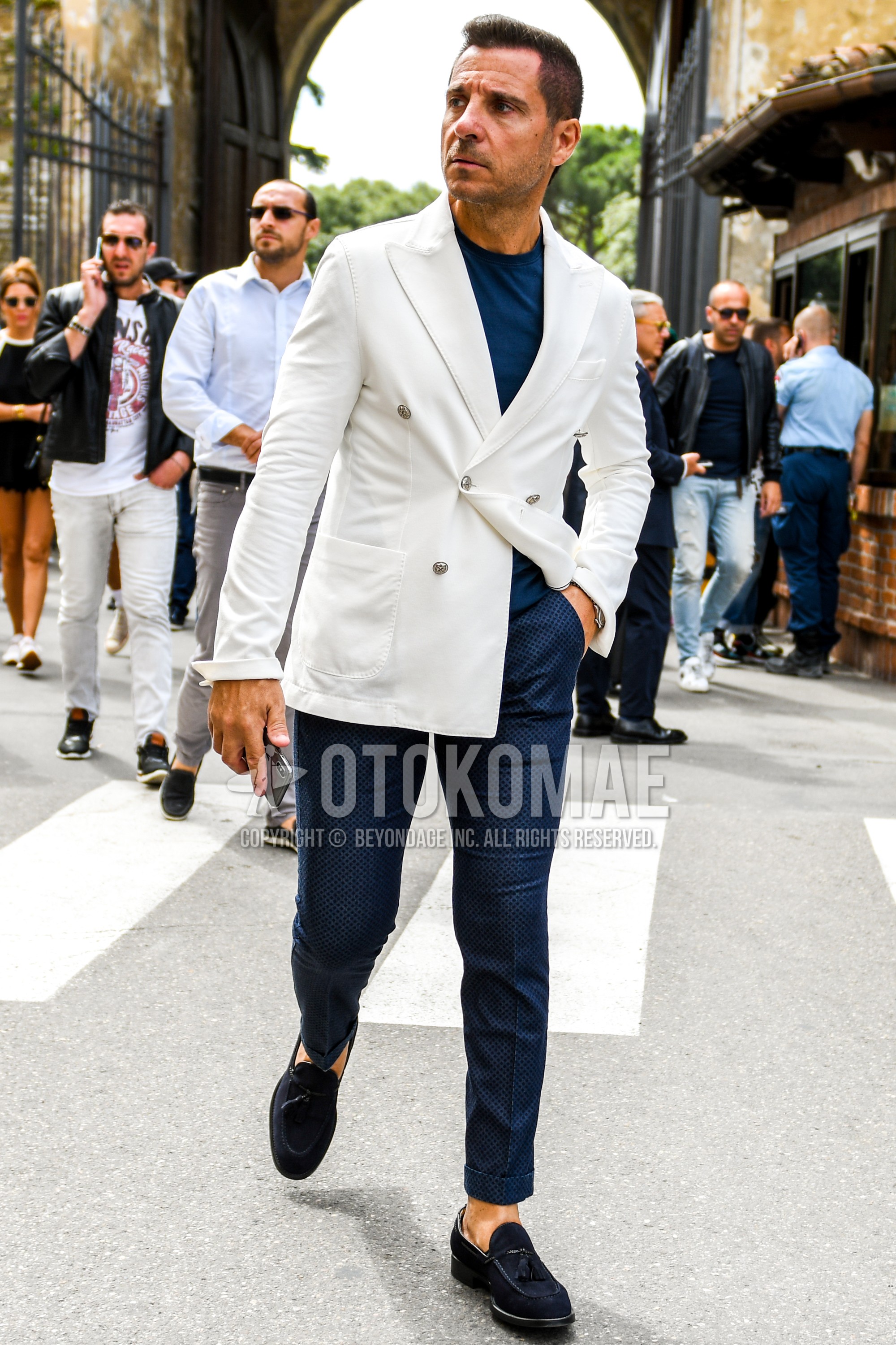 Men's spring summer autumn outfit with white plain tailored jacket, navy plain t-shirt, navy bottoms slacks, navy tassel loafers leather shoes.