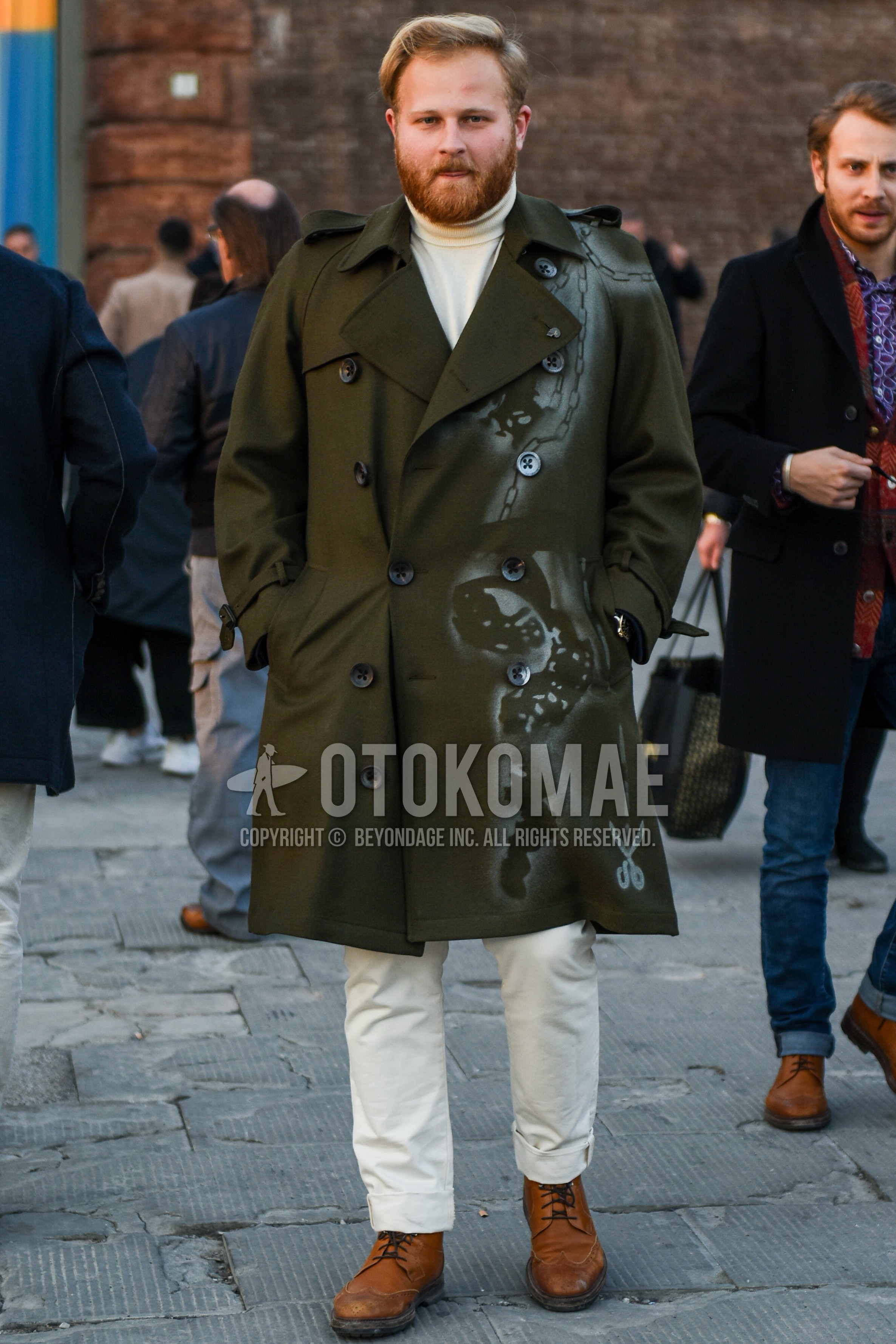 Men's autumn winter outfit with olive green graphic trench coat, white plain turtleneck knit, white plain cotton pants, brown  boots.