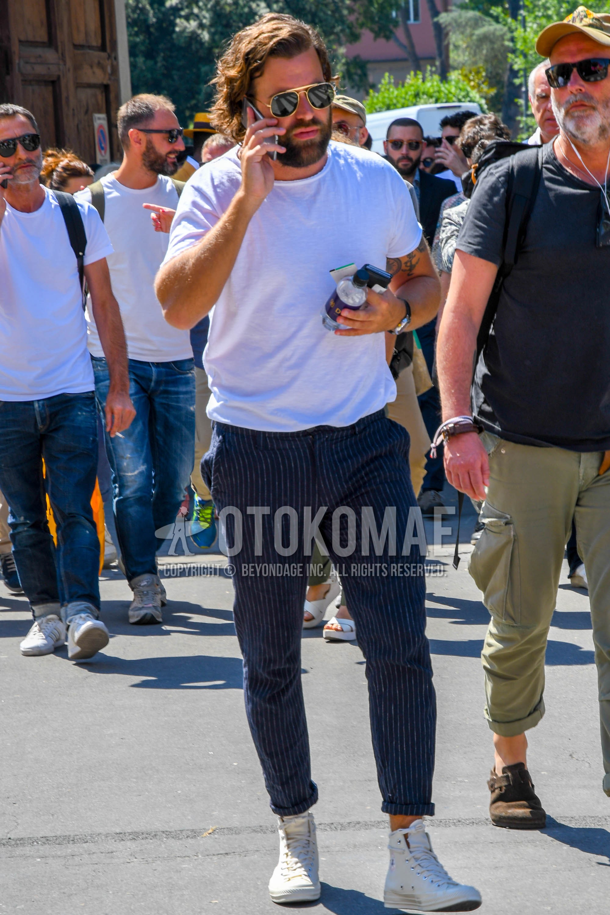 Men's summer outfit with plain sunglasses, white plain t-shirt, navy stripes slacks, white high-cut sneakers.