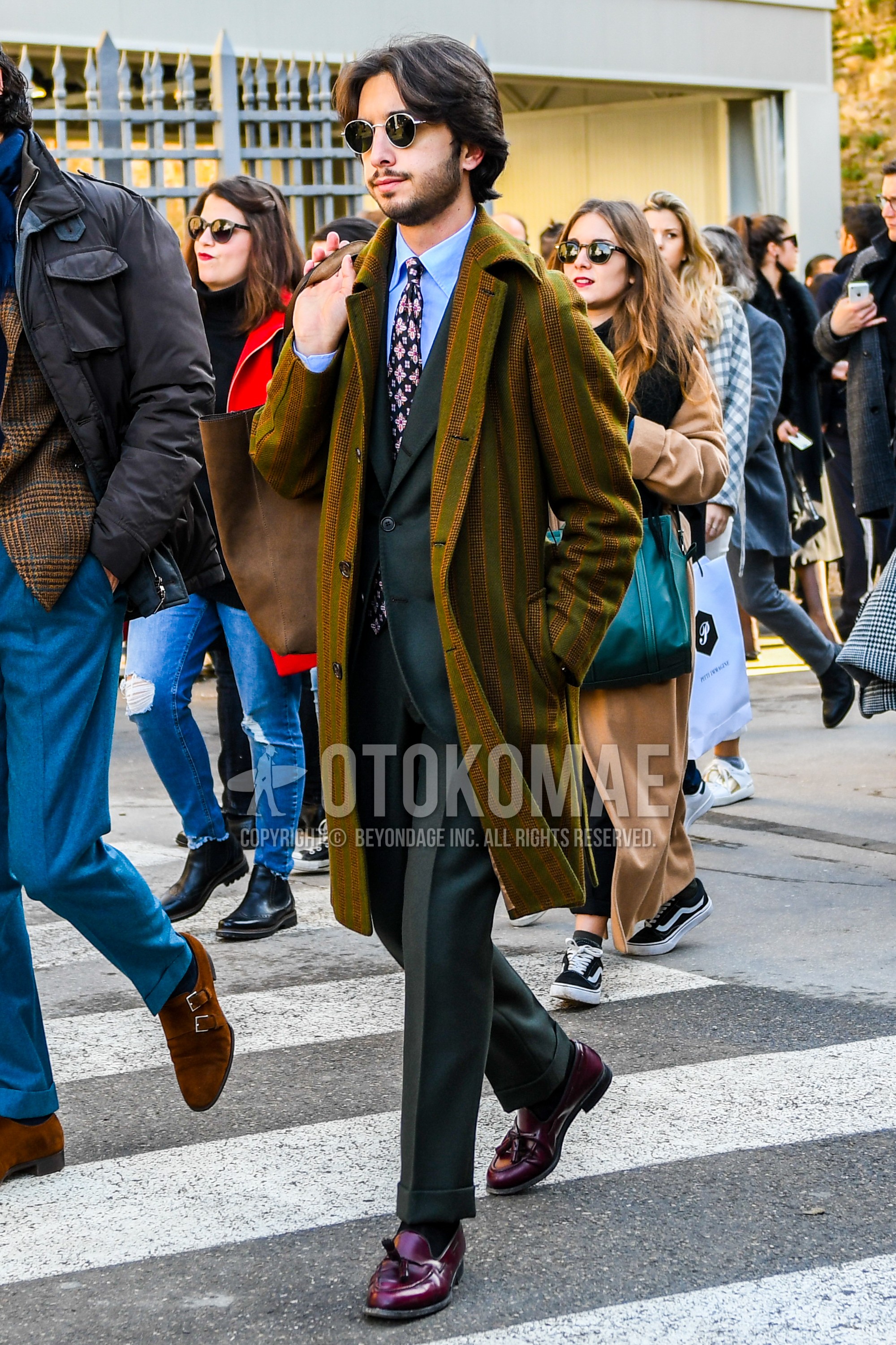 Men's winter outfit with plain sunglasses, brown olive green stripes chester coat, light blue plain shirt, black plain socks, red tassel loafers leather shoes, green plain suit, navy botanical necktie.