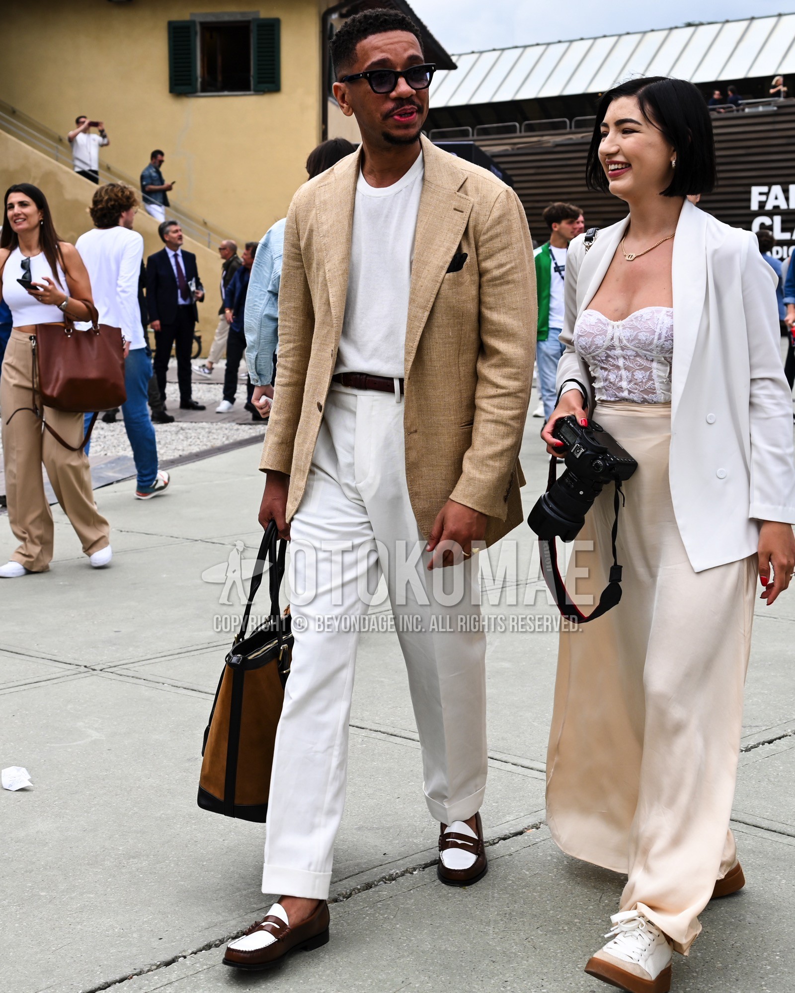 Men's spring summer autumn outfit with black plain sunglasses, beige plain tailored jacket, white plain t-shirt, black plain leather belt, white plain slacks, brown white coin loafers leather shoes, brown plain tote bag.