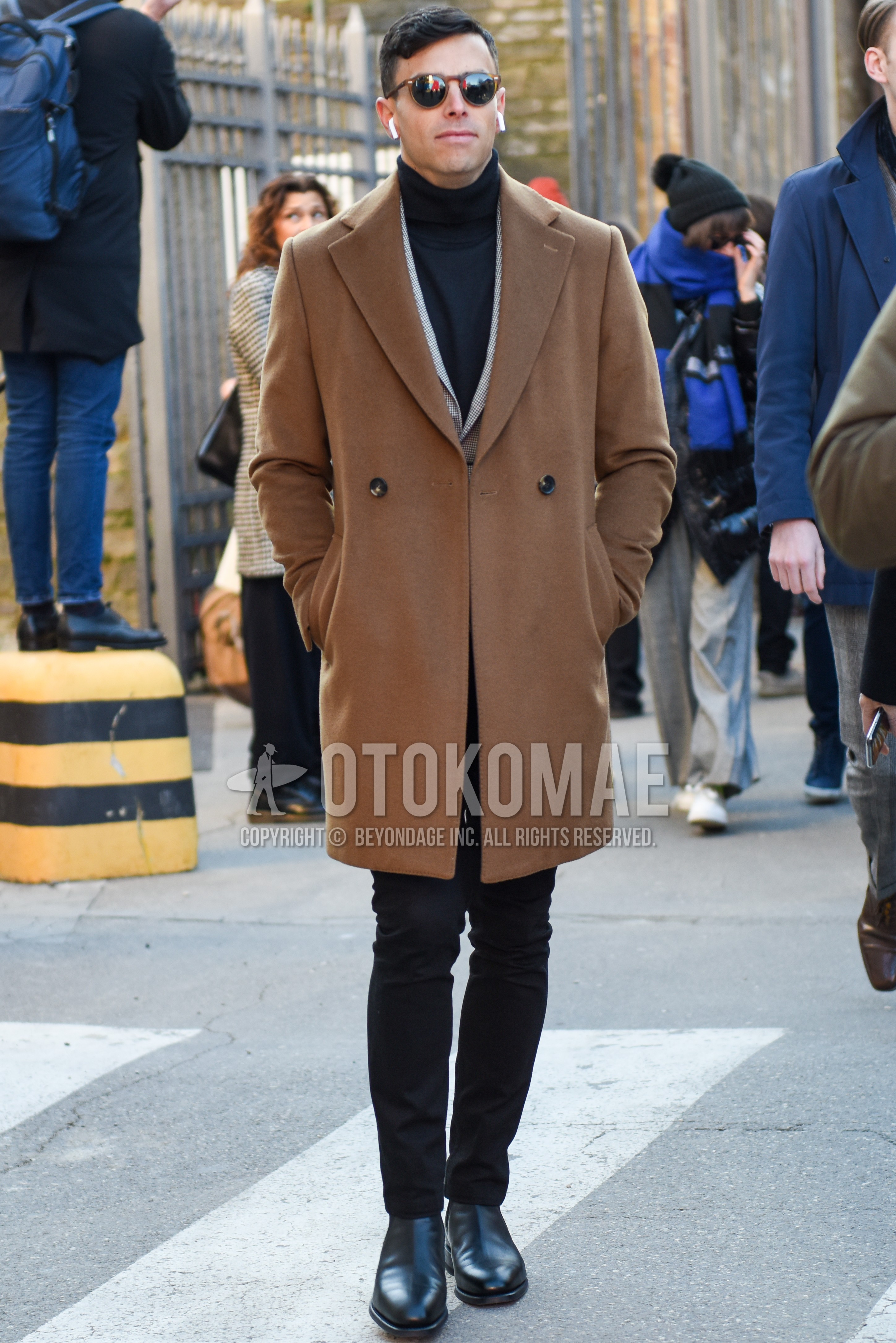 Men's autumn winter outfit with brown tortoiseshell sunglasses, beige plain chester coat, gray check tailored jacket, dark gray plain turtleneck knit, black plain denim/jeans, black side-gore boots.