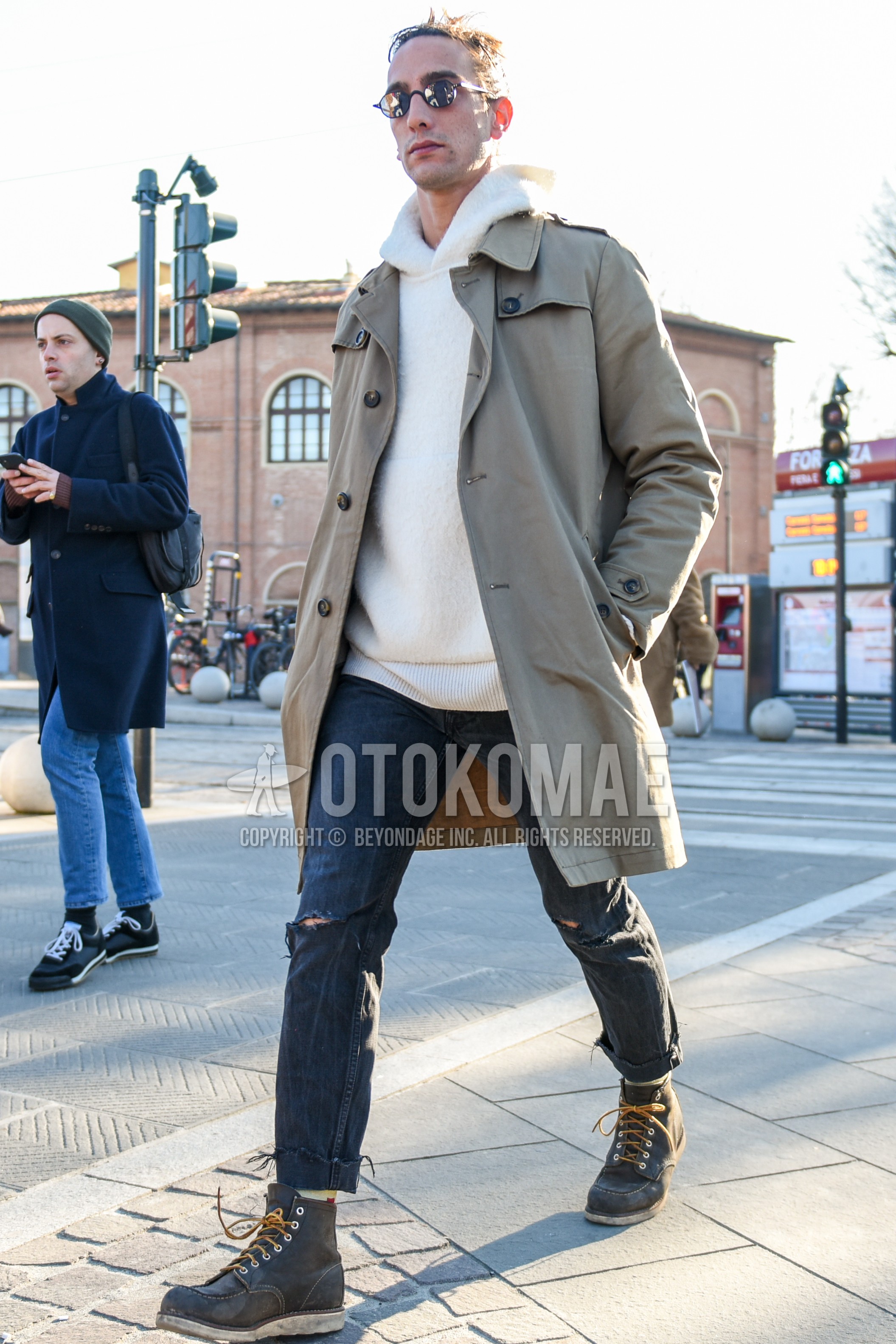 Men's autumn winter outfit with silver plain sunglasses, beige plain trench coat, white plain hoodie, gray plain denim/jeans, brown work boots.