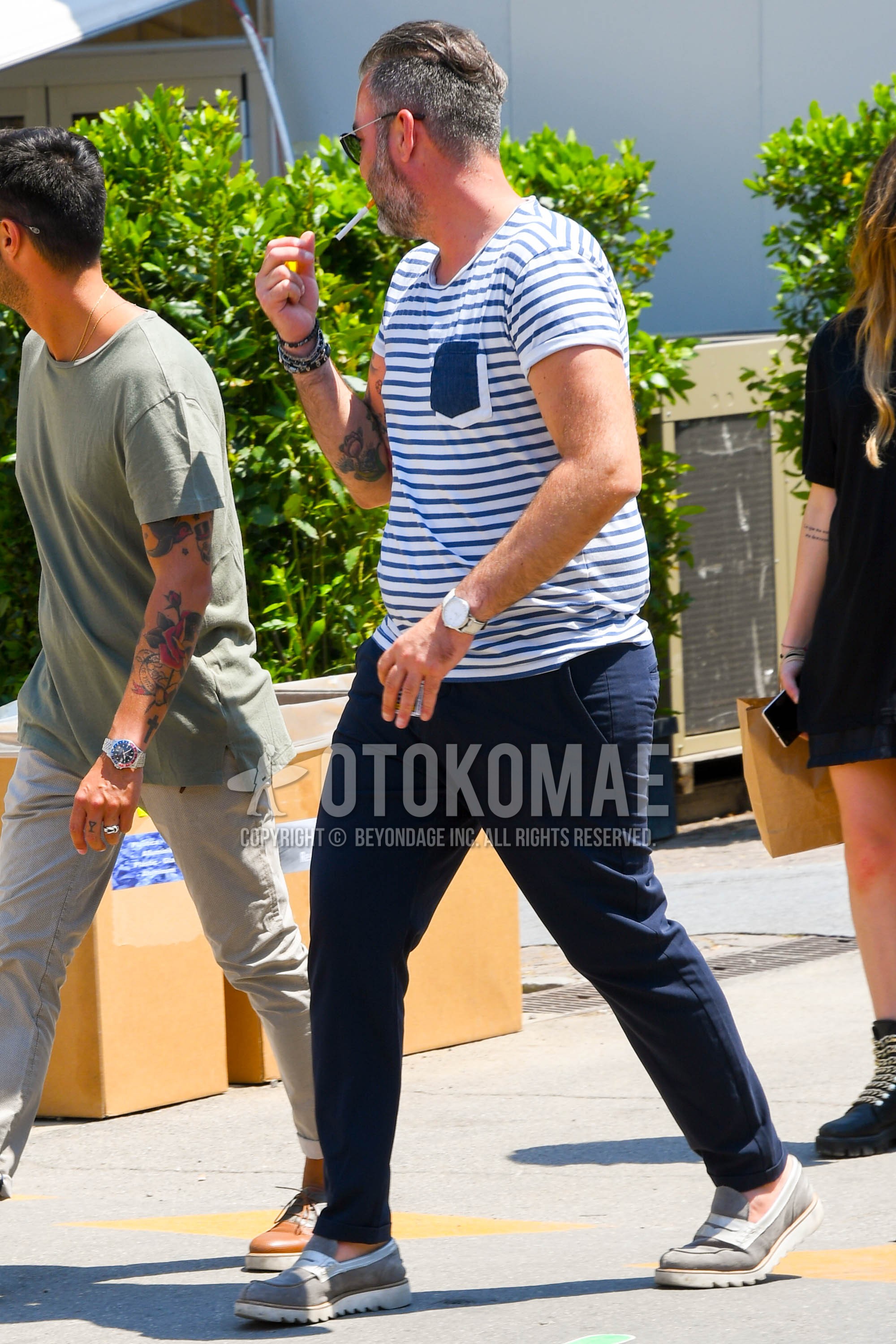 Men's summer outfit with plain sunglasses, white blue plain t-shirt, blue plain cotton pants, gray slip-on sneakers.