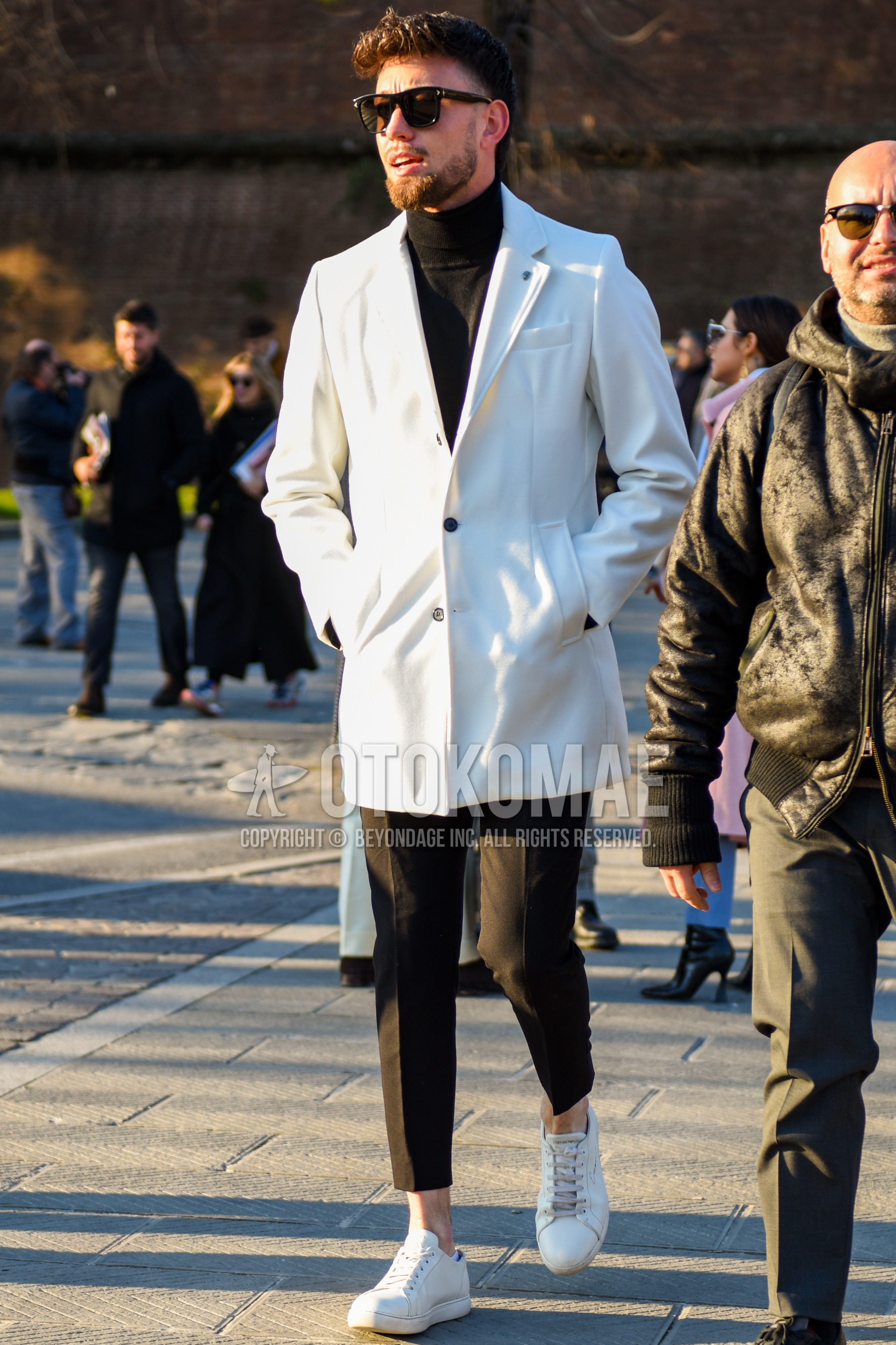 Men's autumn winter outfit with black plain sunglasses, white plain chester coat, black plain turtleneck knit, dark gray plain slacks, dark gray plain cropped pants, white low-cut sneakers.
