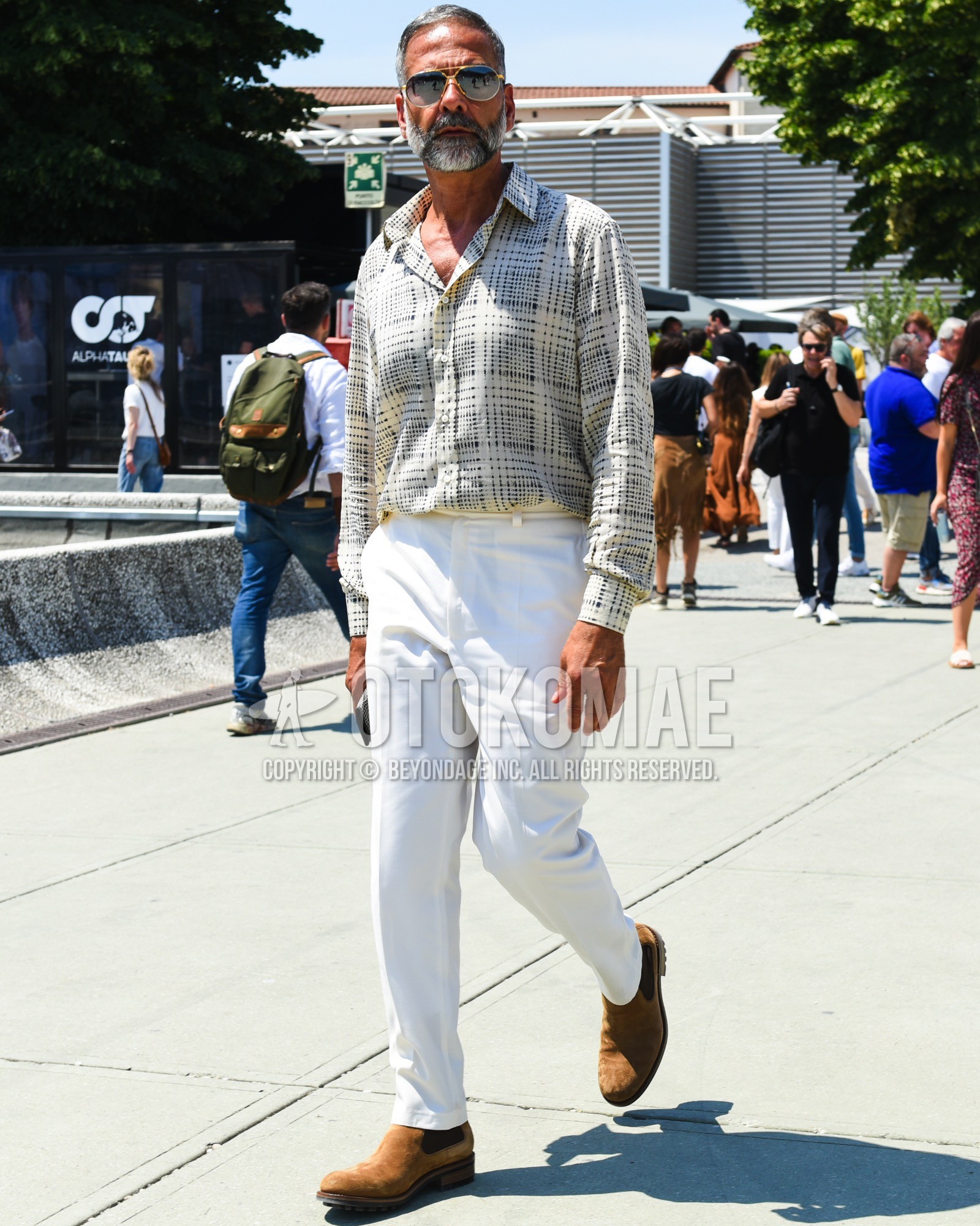 Men's spring summer outfit with silver plain sunglasses, beige check shirt, white plain slacks, brown side-gore boots.