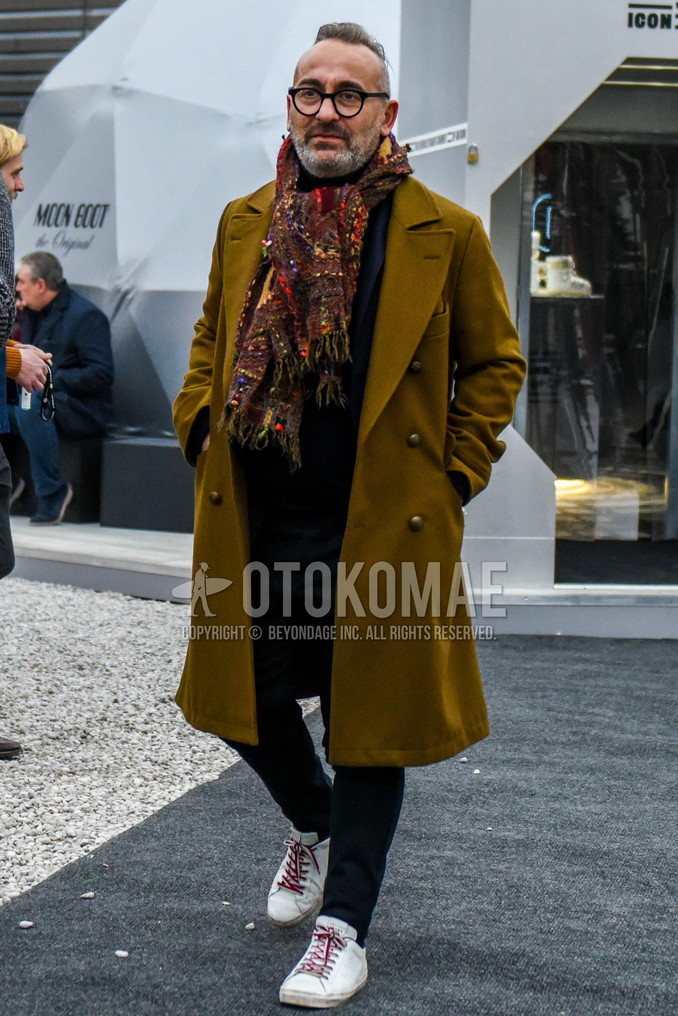 Men's winter outfit with black plain glasses, multi-color scarf scarf, brown plain ulster coat, white low-cut sneakers, gray plain suit.