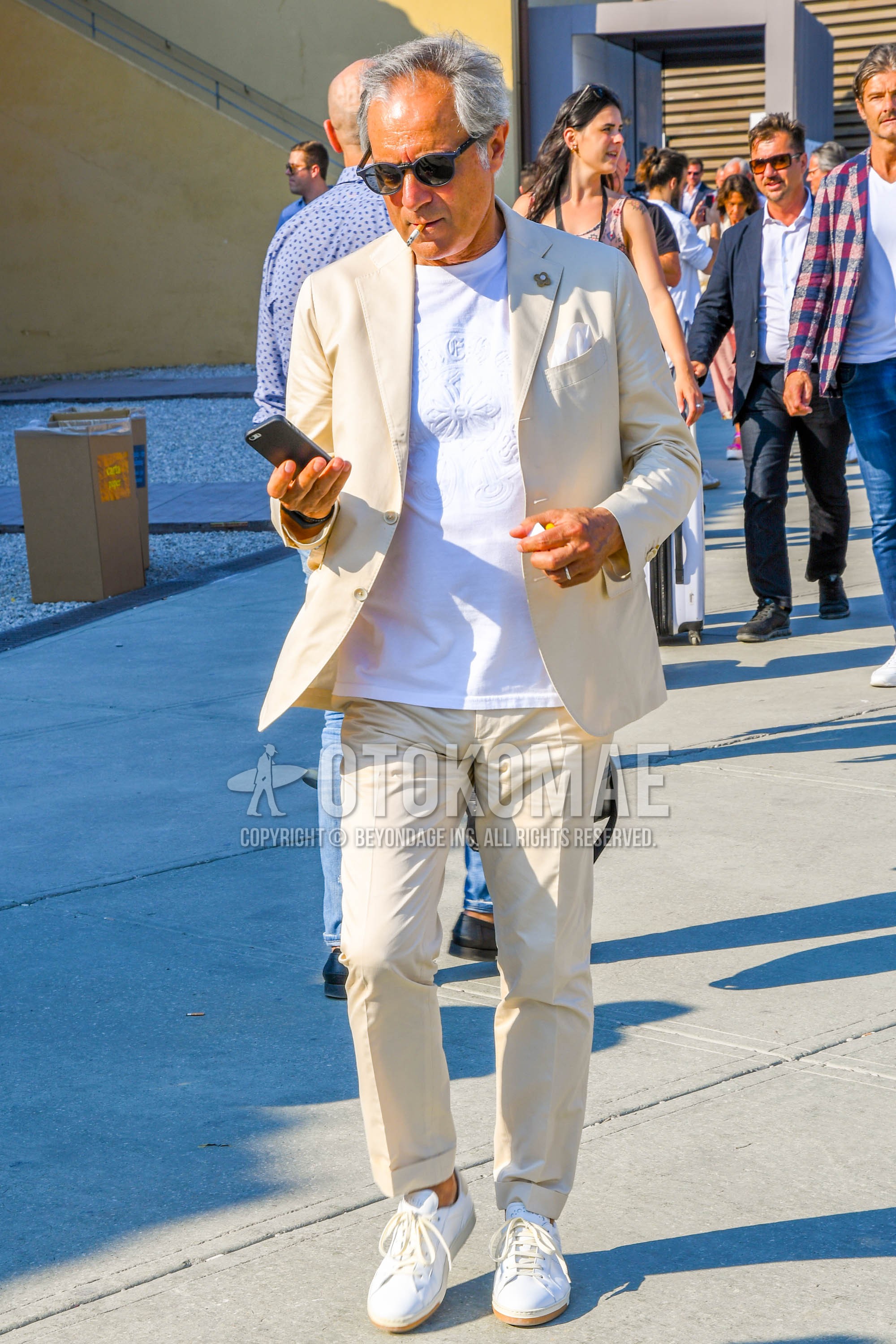 Men's spring summer autumn outfit with plain sunglasses, white plain t-shirt, white low-cut sneakers, beige plain suit.