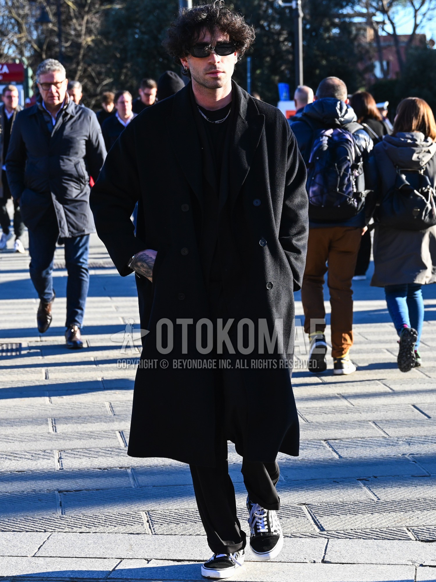 Men's autumn winter outfit with black plain sunglasses, black plain chester coat, black plain t-shirt, black low-cut sneakers, black plain casual setup.