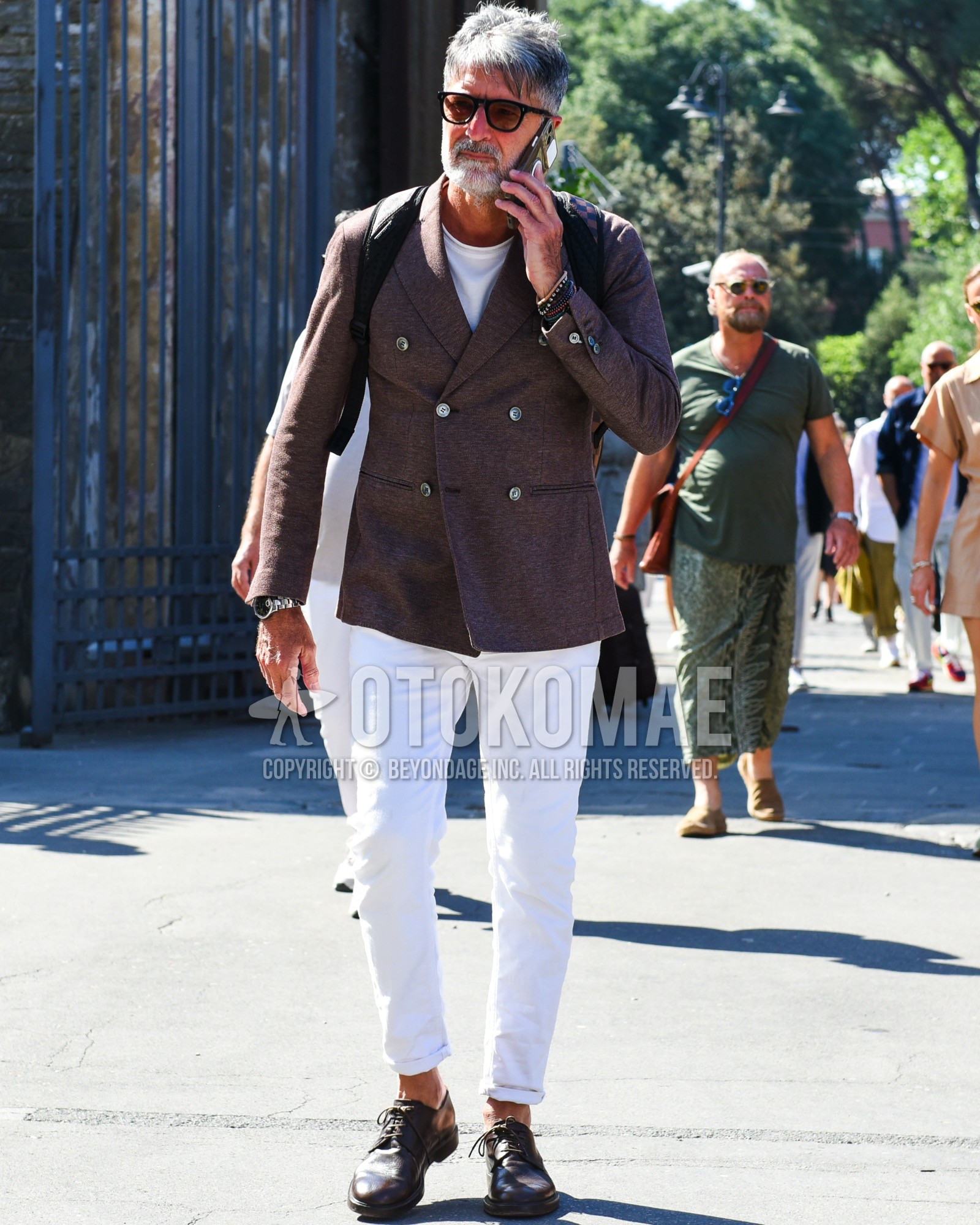 Men's spring summer outfit with black plain sunglasses, brown plain tailored jacket, white plain t-shirt, white plain cotton pants, white plain ankle pants, brown plain toe leather shoes, black plain backpack.