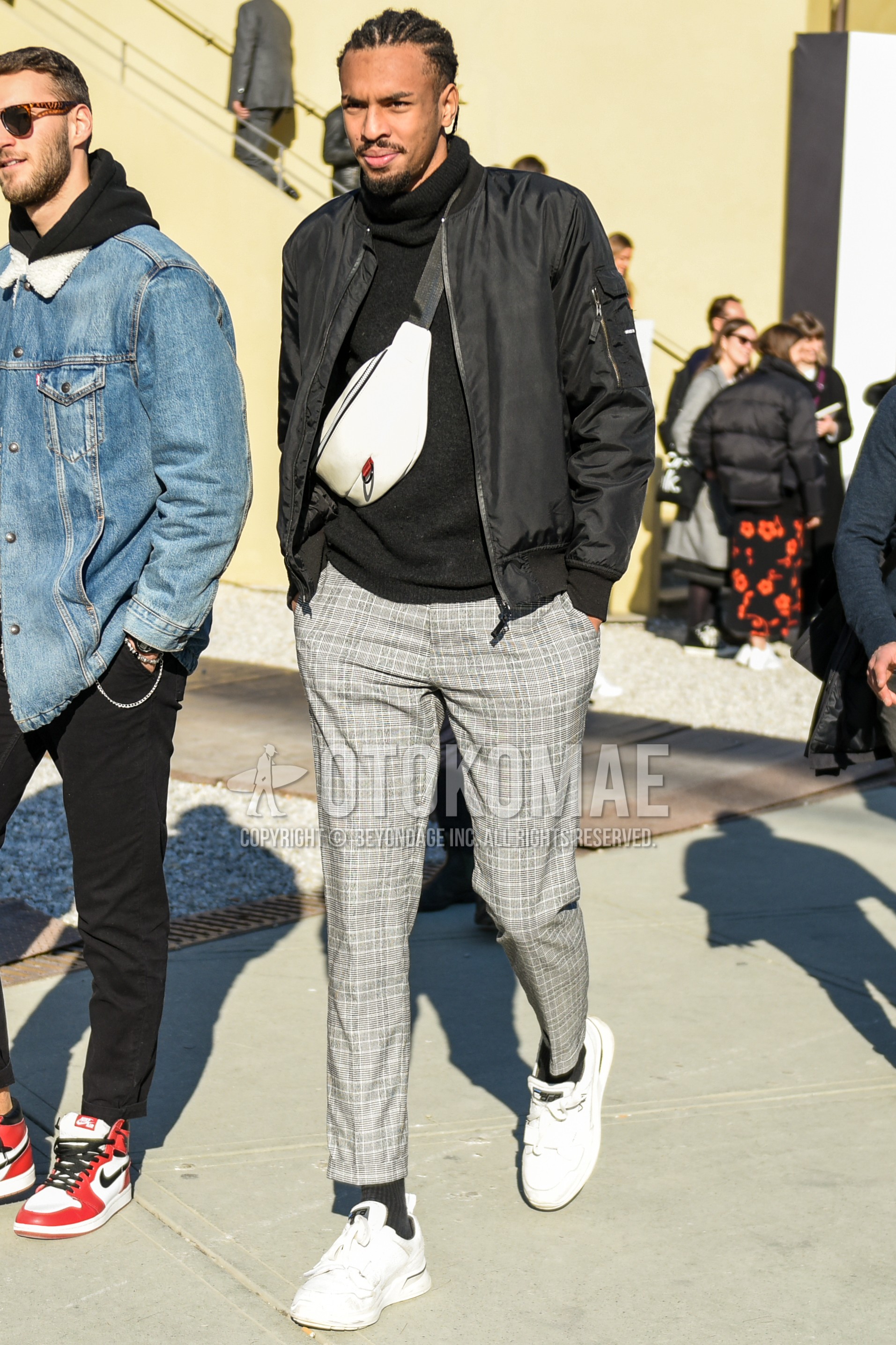 Men's autumn winter outfit with black plain MA-1, black plain turtleneck knit, gray check slacks, gray check ankle pants, black plain socks, white low-cut sneakers, white plain shoulder bag.