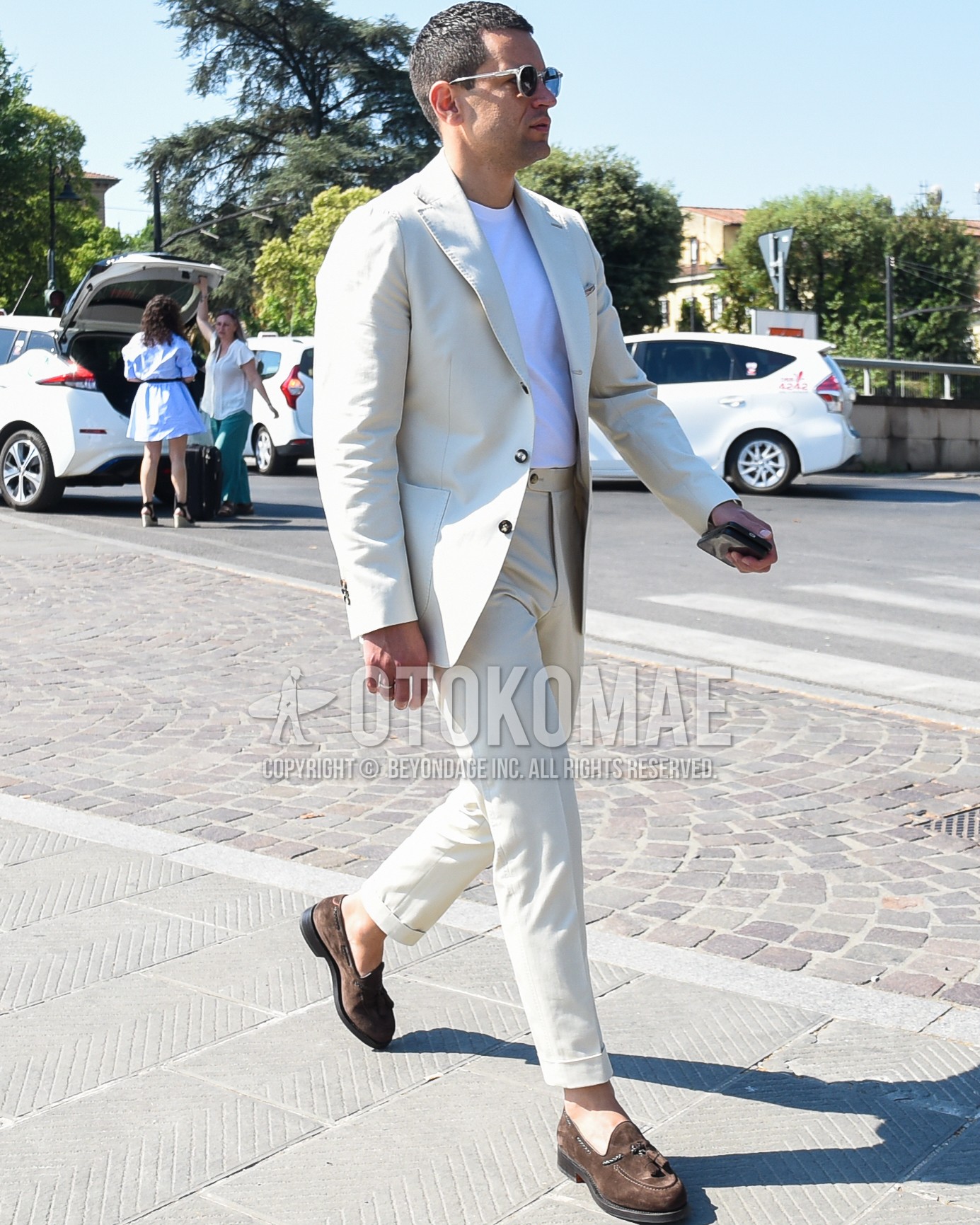 Men's spring summer outfit with gray plain sunglasses, white plain t-shirt, brown tassel loafers leather shoes, white plain suit.