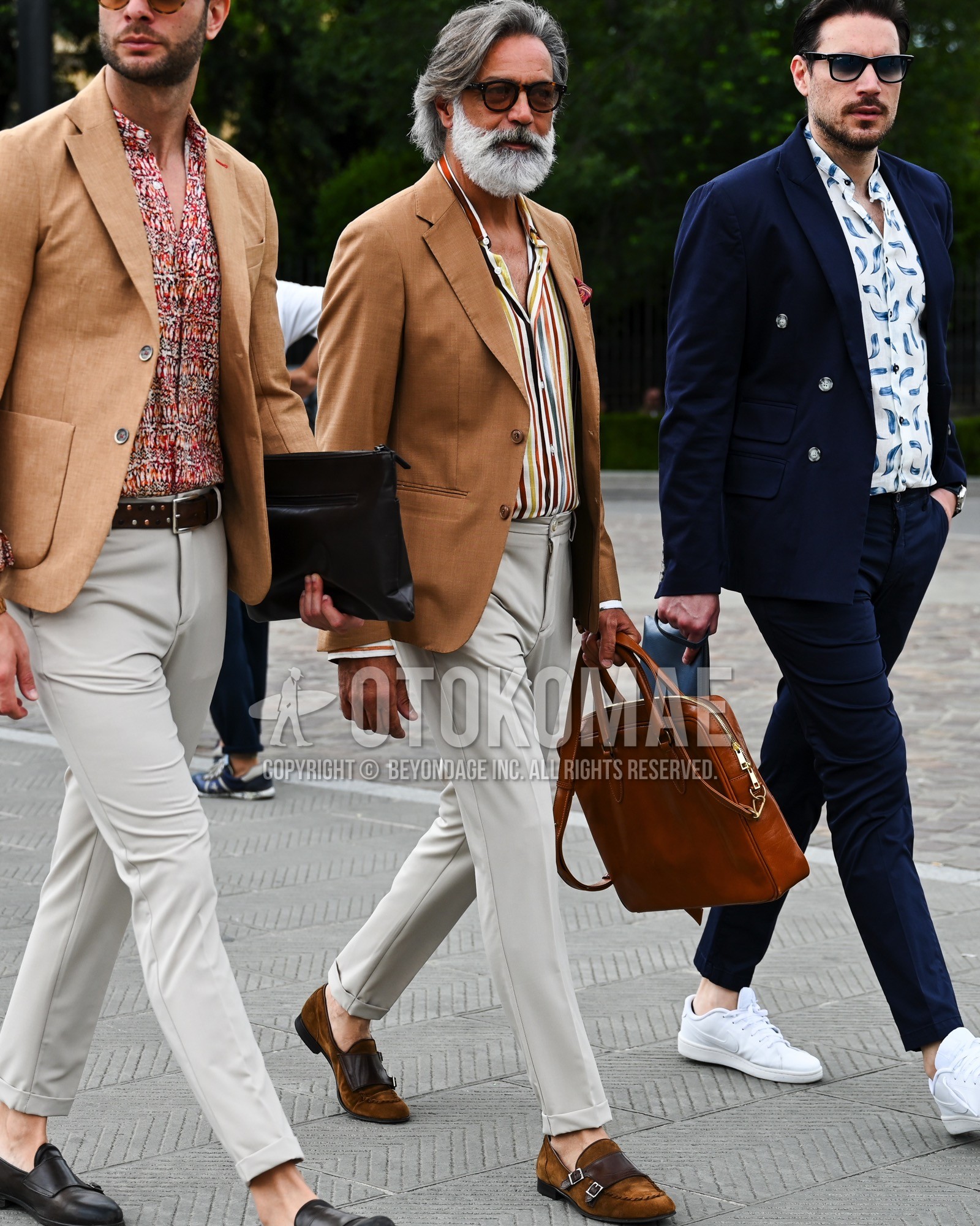 Men's spring summer autumn outfit with brown plain glasses, brown plain tailored jacket, multi-color stripes shirt, white beige plain beltless pants, brown  loafers leather shoes, brown suede shoes leather shoes, brown plain briefcase/handbag.