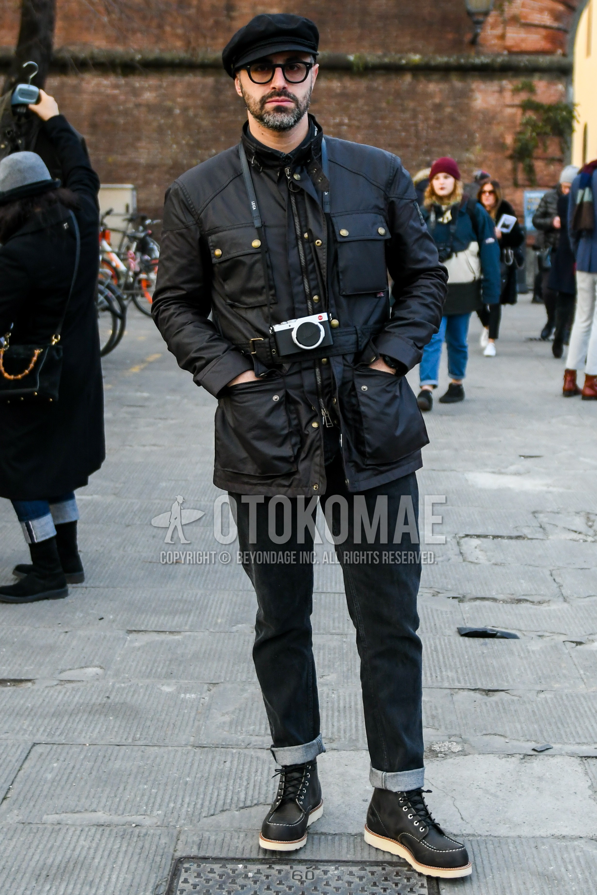 Men's winter outfit with black plain cap, plain sunglasses, black plain field jacket/hunting jacket, black plain denim/jeans, black work boots.