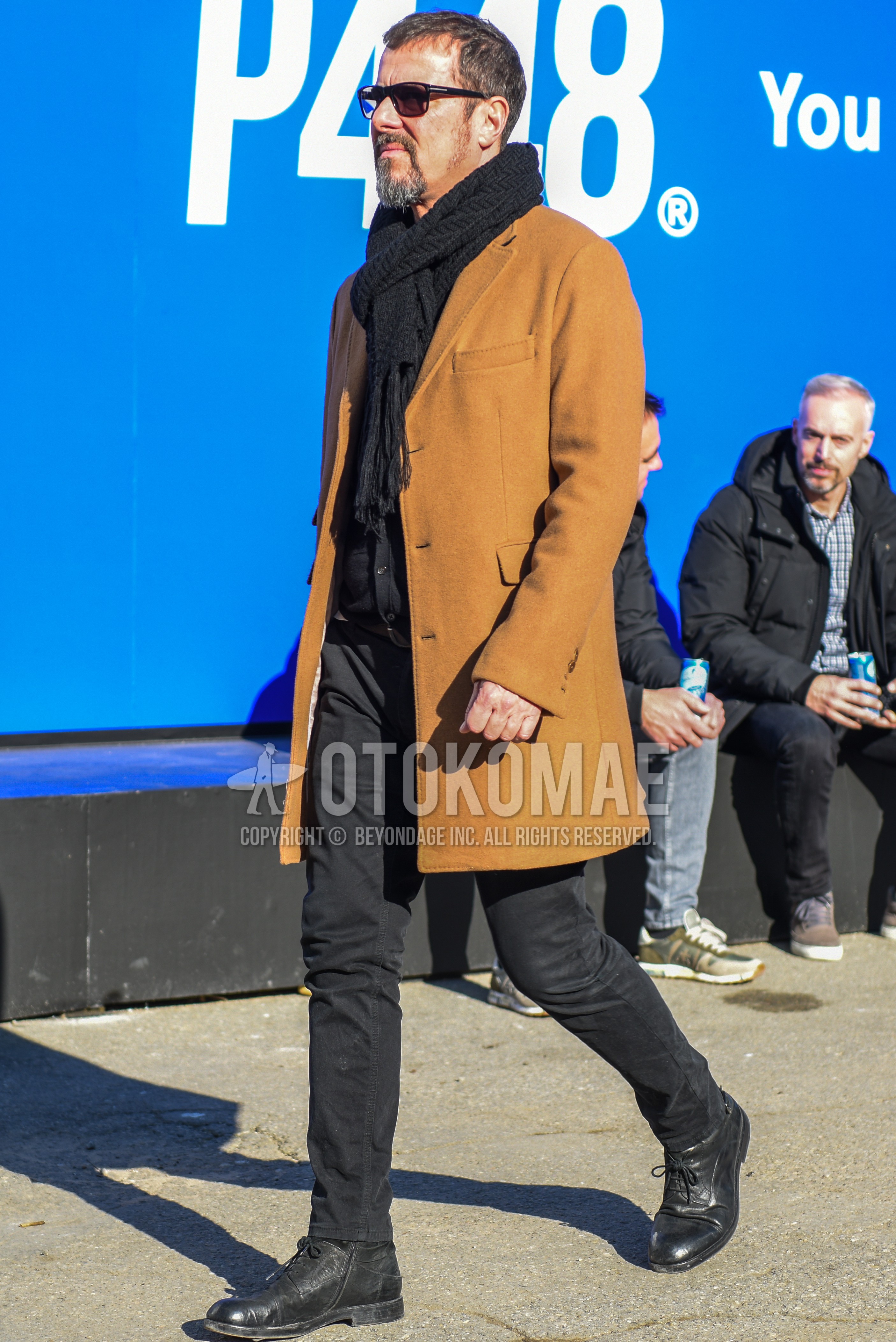Men's autumn winter outfit with black plain sunglasses, black plain scarf, beige plain chester coat, black plain denim/jeans, black  boots.