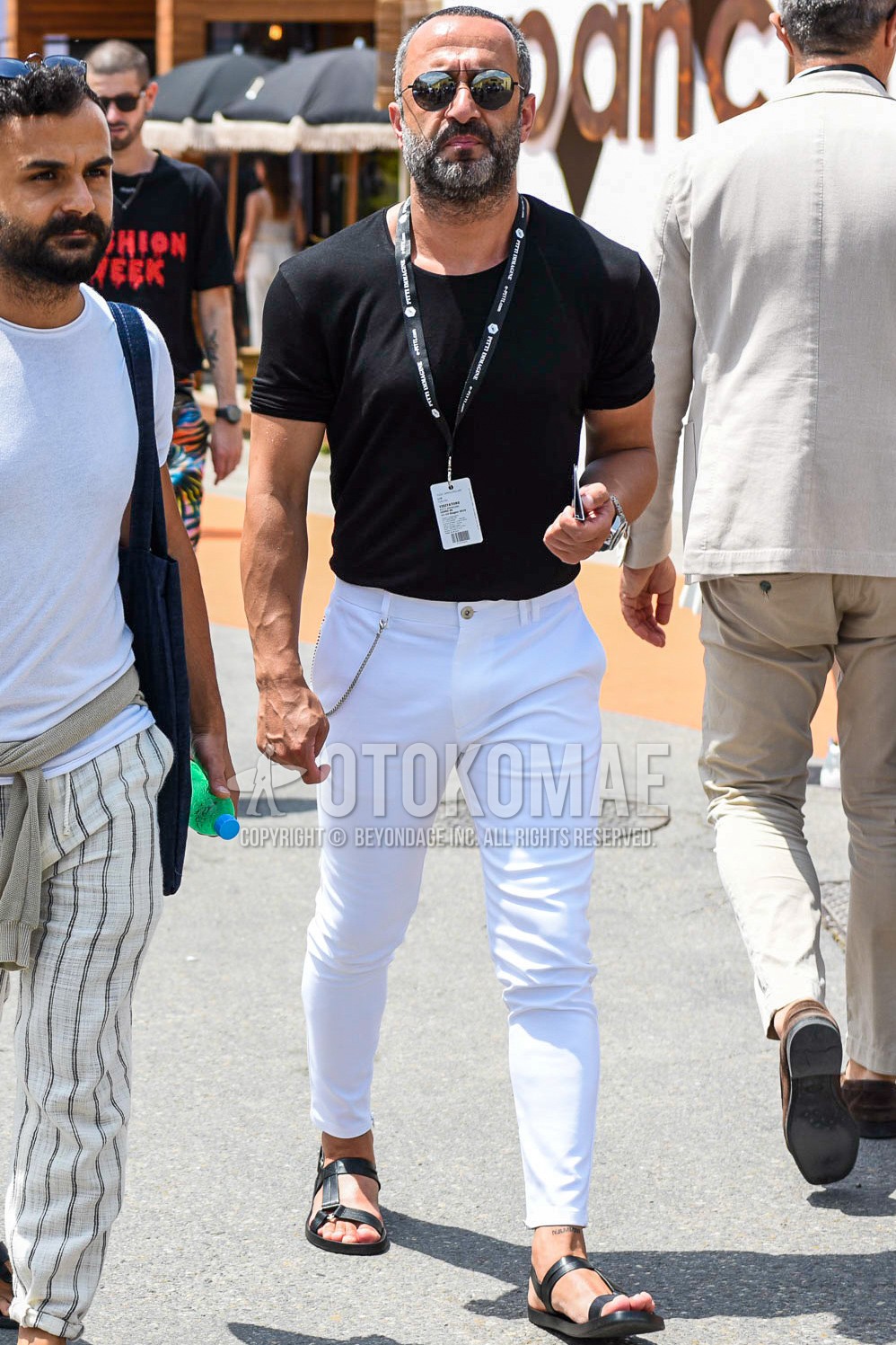 Men's summer outfit with black plain sunglasses, black plain t-shirt, white plain cotton pants, black leather sandals.
