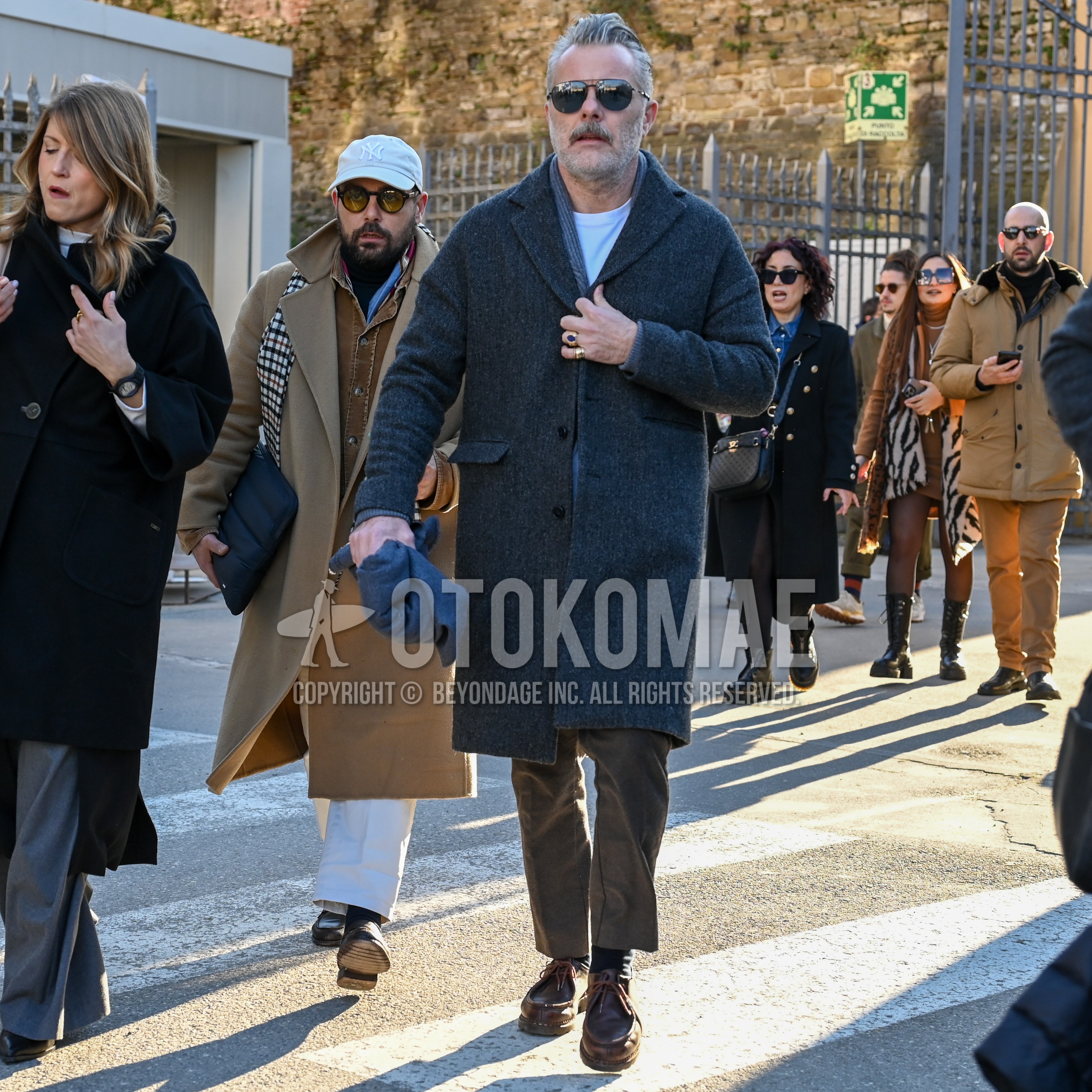 Men's autumn winter outfit with black plain sunglasses, dark gray plain scarf, dark gray plain chester coat, dark gray stripes cardigan, white plain long sleeve t-shirt, brown plain chinos, black plain socks, brown  loafers leather shoes.