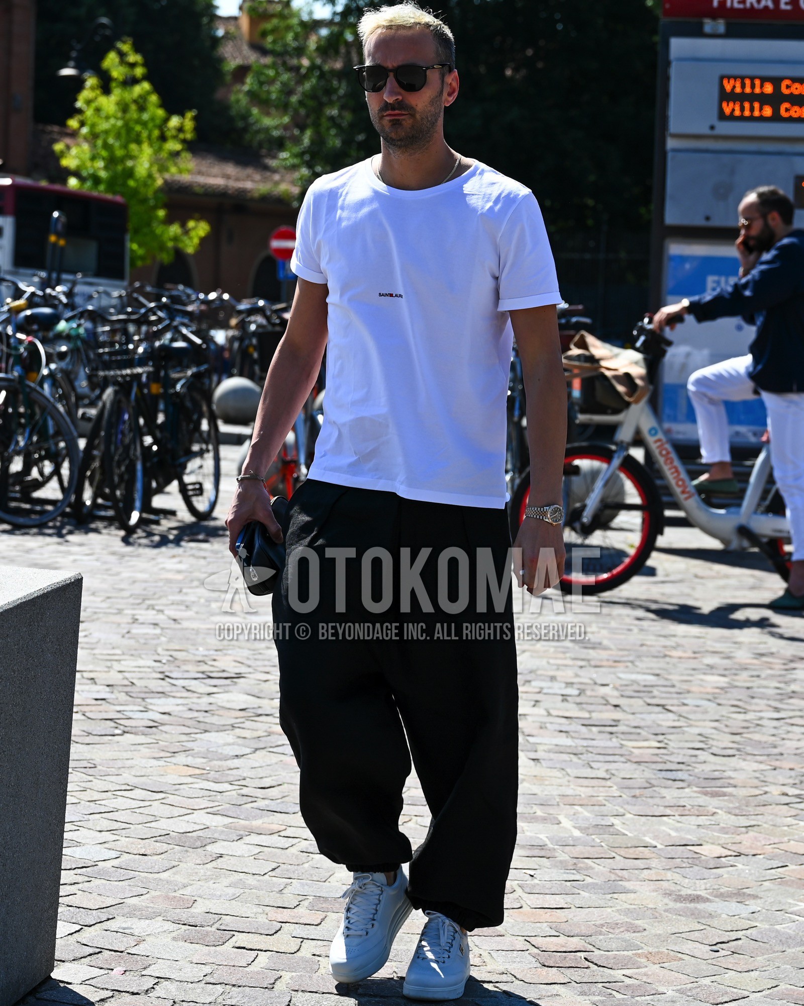 Men's spring summer outfit with black plain sunglasses, white one point t-shirt, black plain wide pants, white low-cut sneakers.