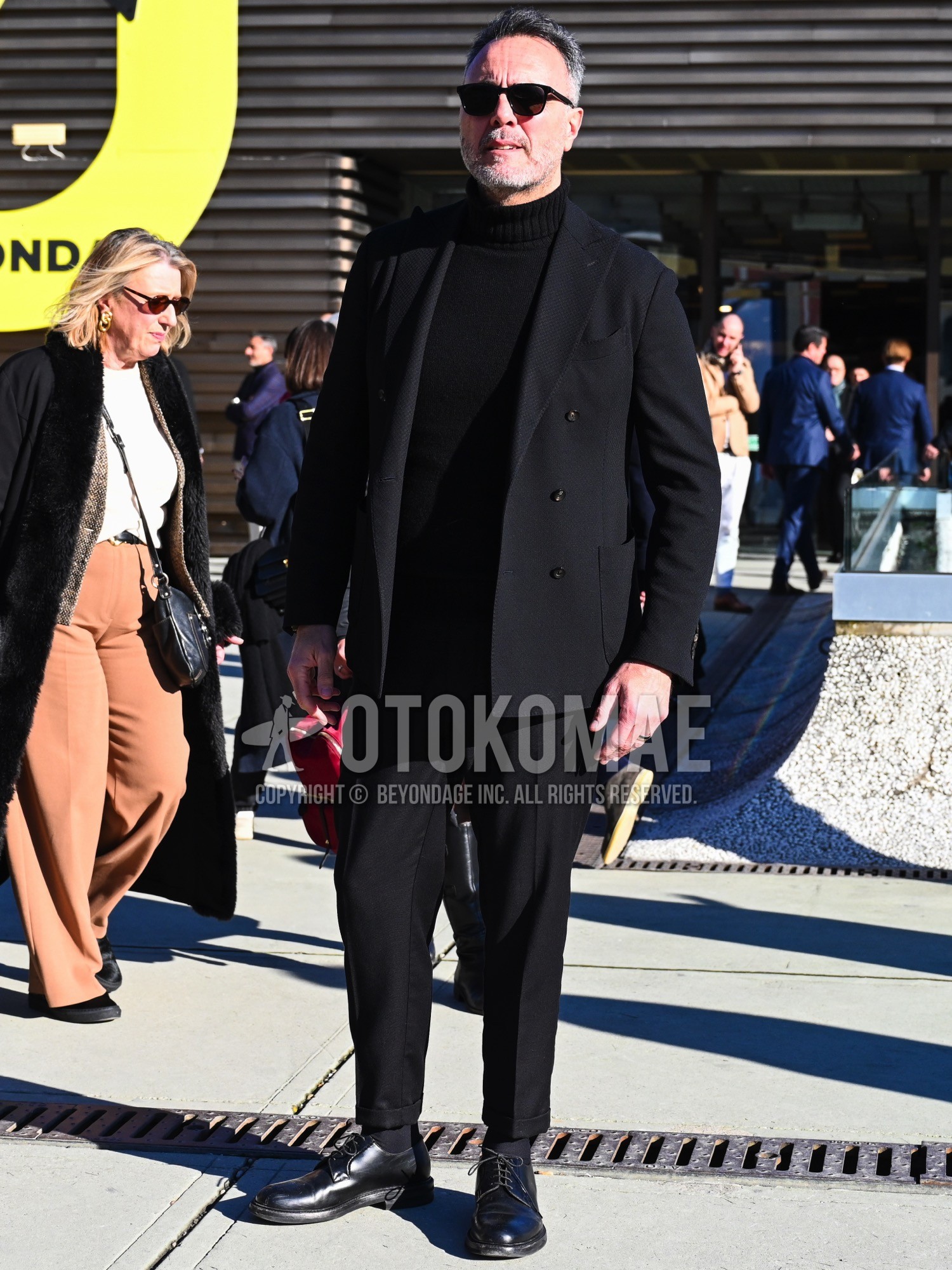 Men's spring autumn winter outfit with black plain sunglasses, black plain turtleneck knit, black plain socks, black plain toe leather shoes, black plain suit.