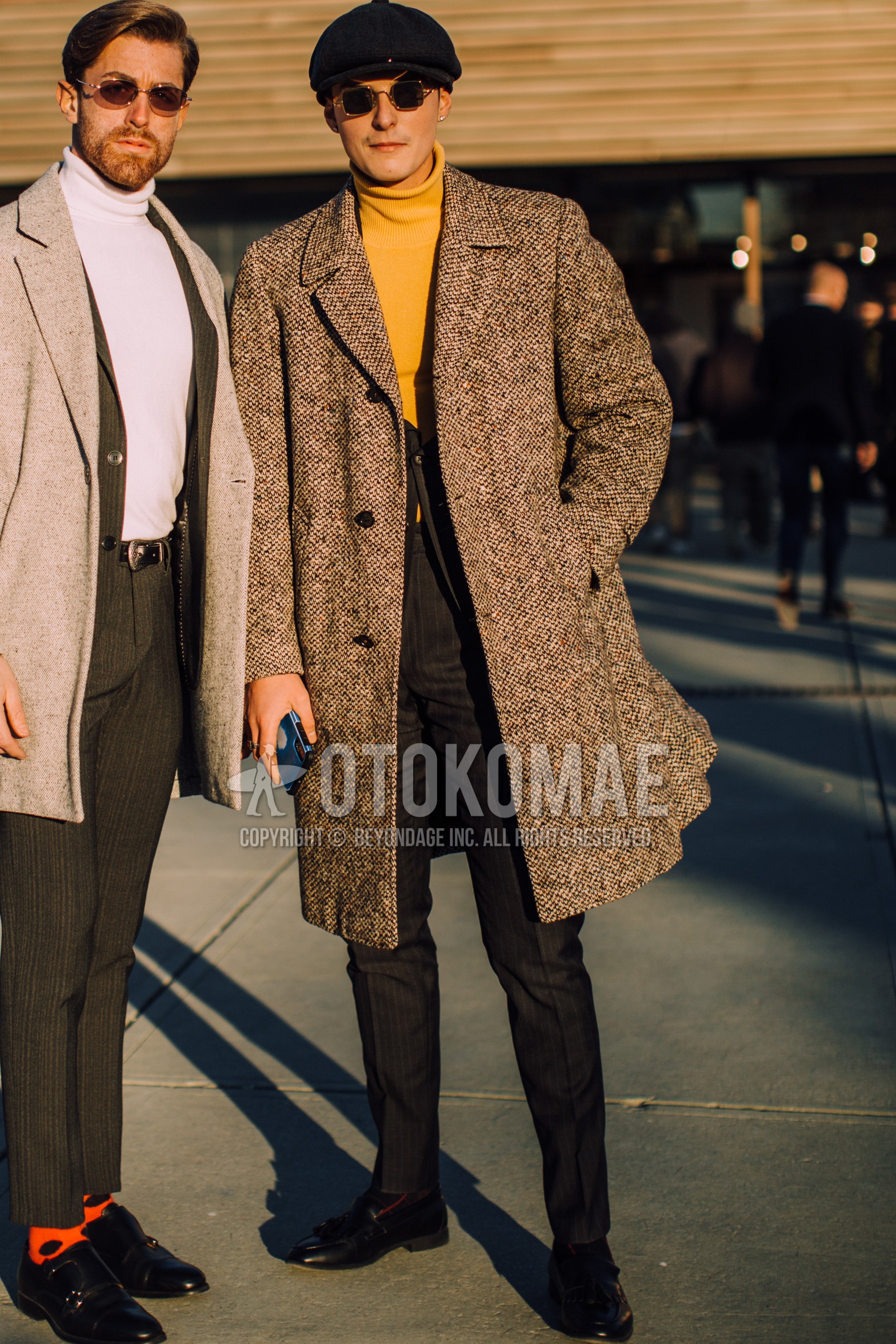 Men's spring winter outfit with black plain hunting cap, silver plain sunglasses, brown check ulster coat, yellow plain turtleneck knit, black tassel loafers leather shoes, black stripes suit.
