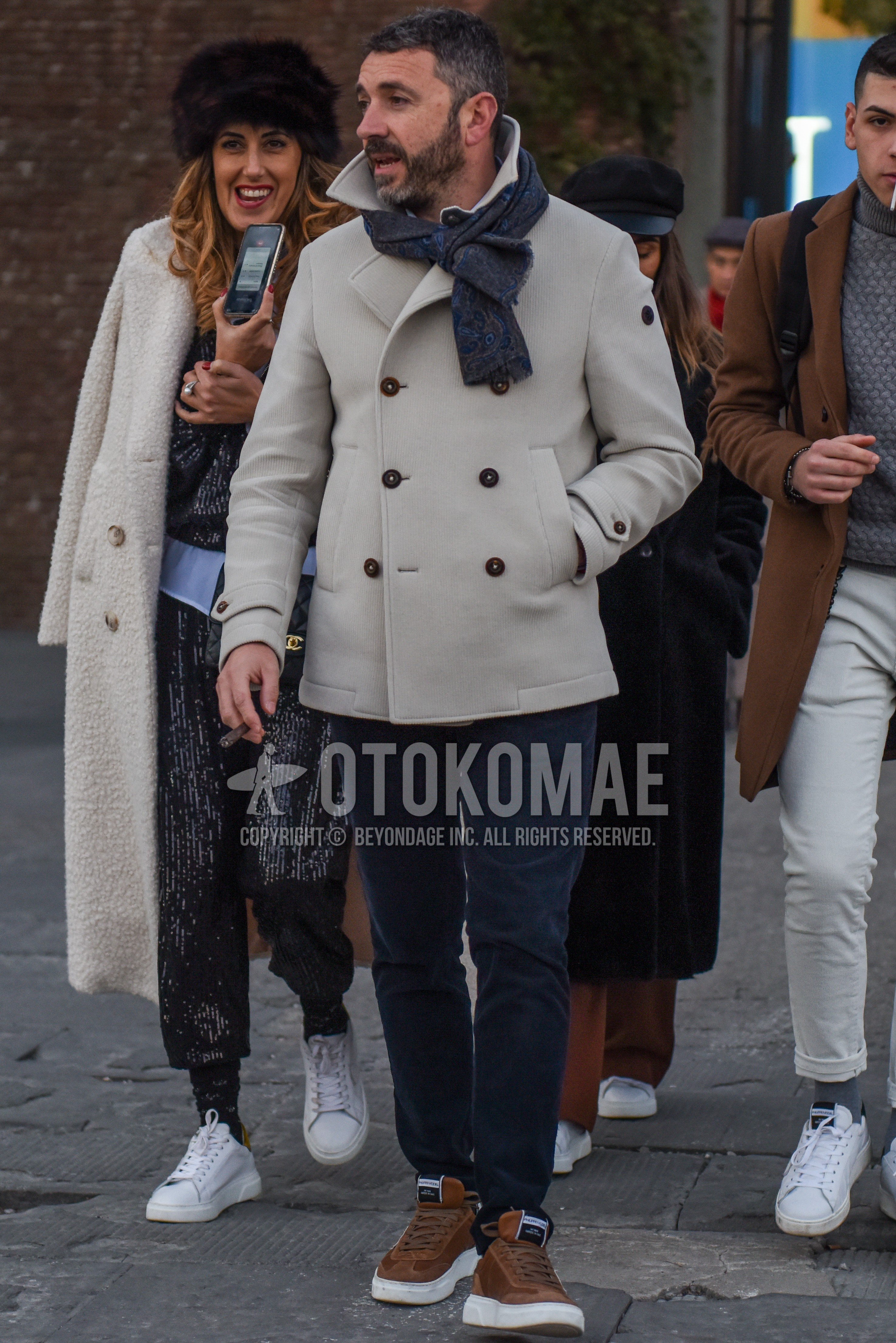 Men's autumn winter outfit with gray scarf scarf, white plain p coat, gray plain chinos, brown low-cut sneakers.