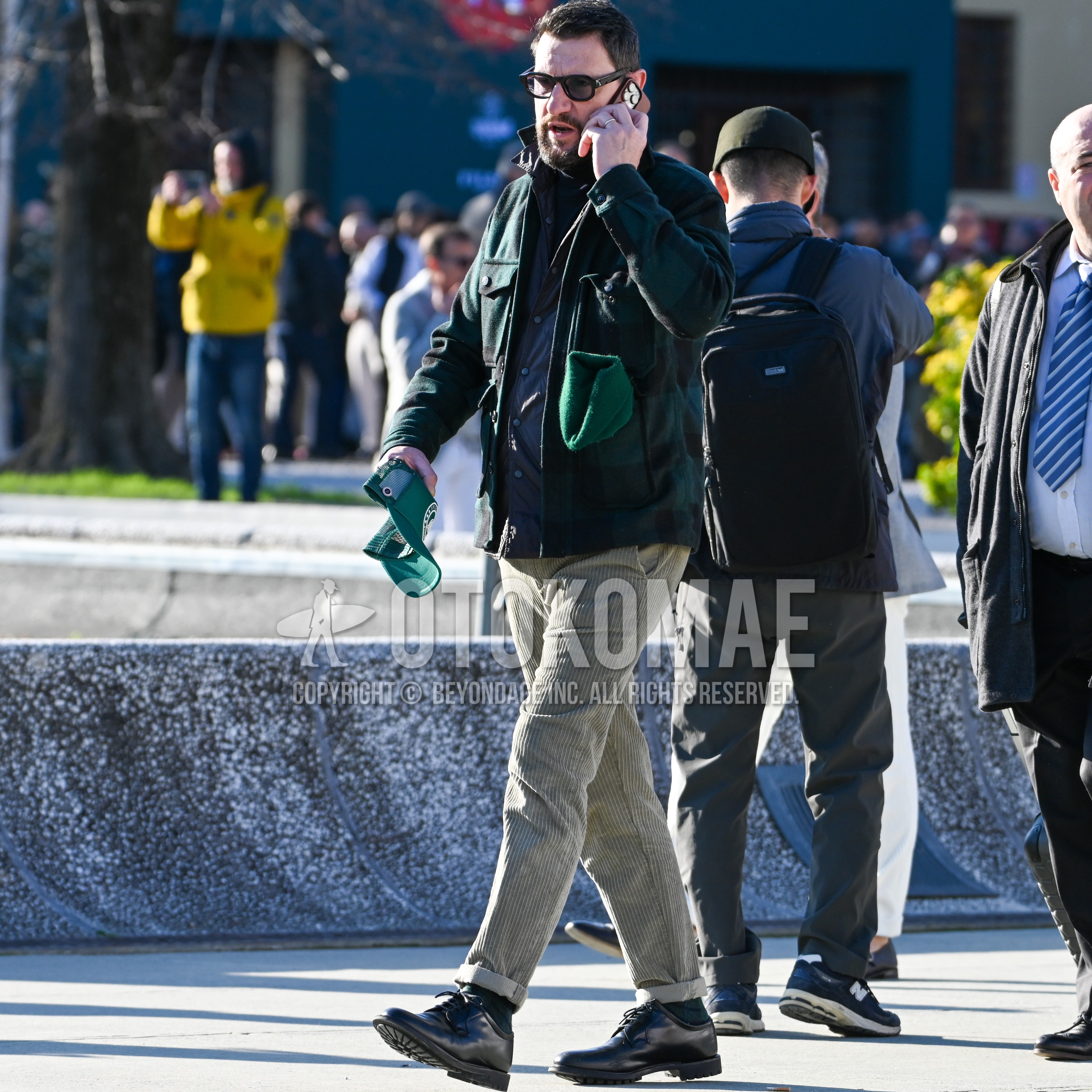 Men's autumn winter outfit with black plain sunglasses, green check shirt jacket, navy plain shirt, beige plain winter pants (corduroy,velour), black plain socks, black plain toe leather shoes.