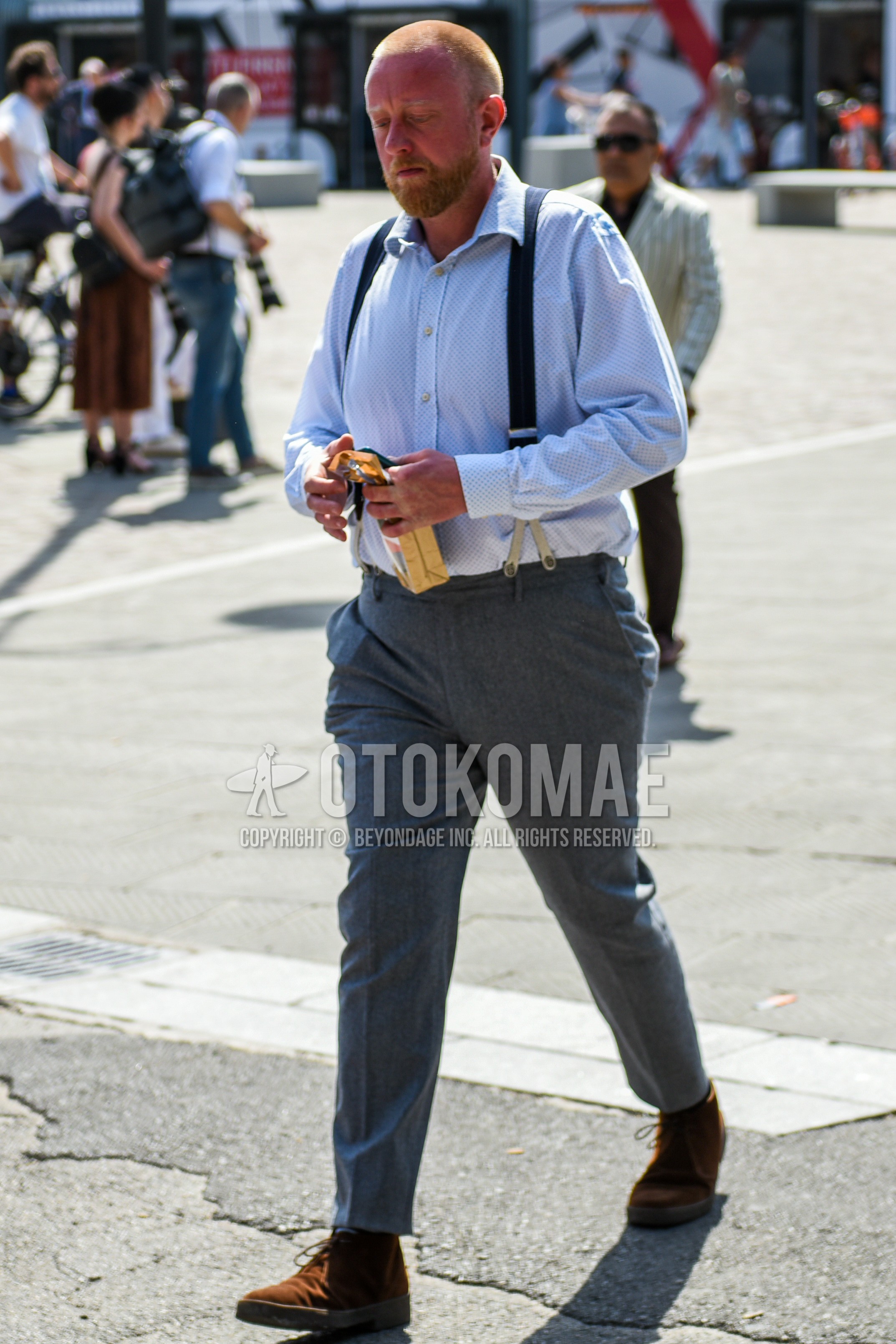 Men's spring summer outfit with white tops/innerwear shirt, black plain suspenders, gray plain slacks, brown chukka boots.
