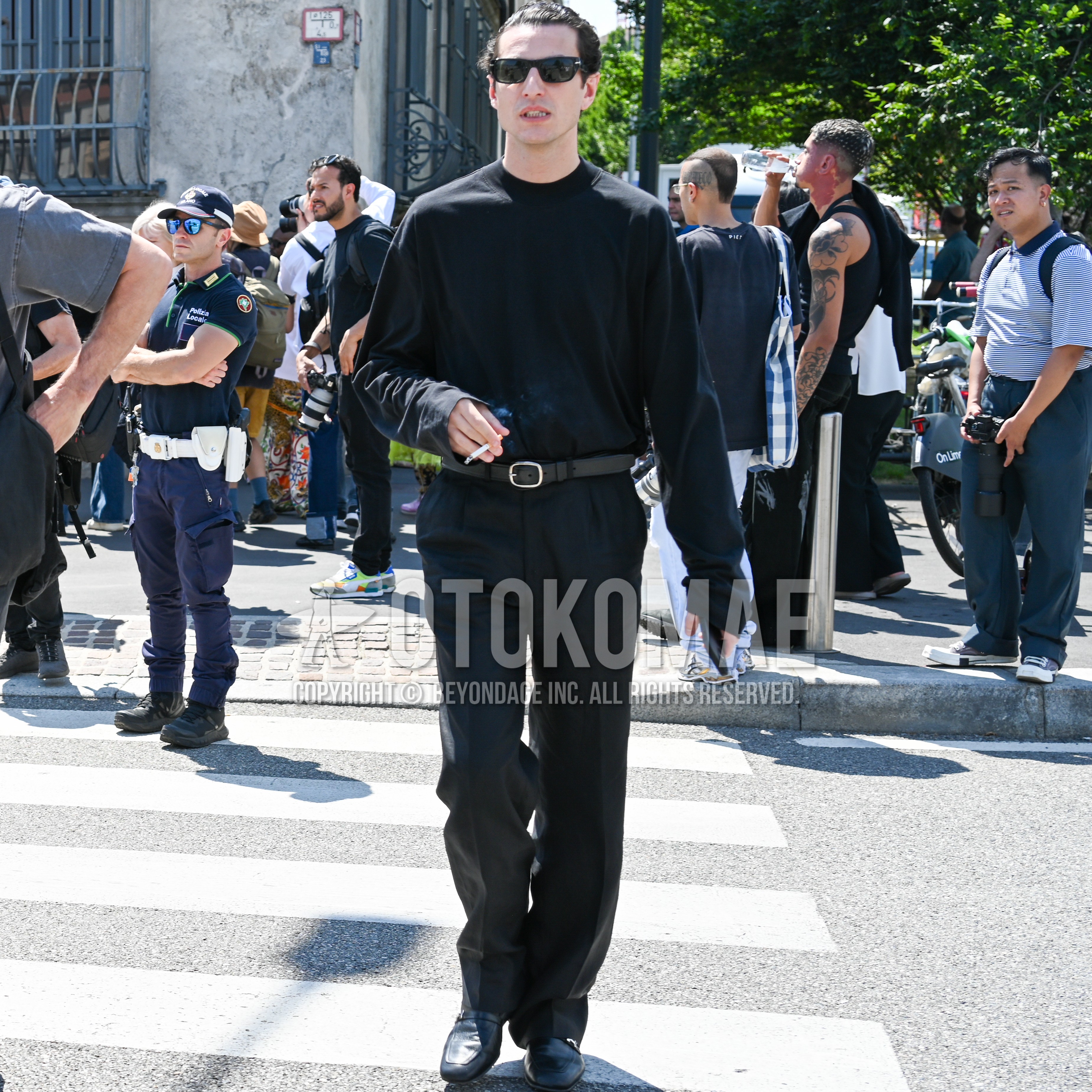 Men's spring outfit with black plain sunglasses, black plain long sleeve t-shirt, black plain leather belt, black plain slacks, black monk shoes leather shoes.