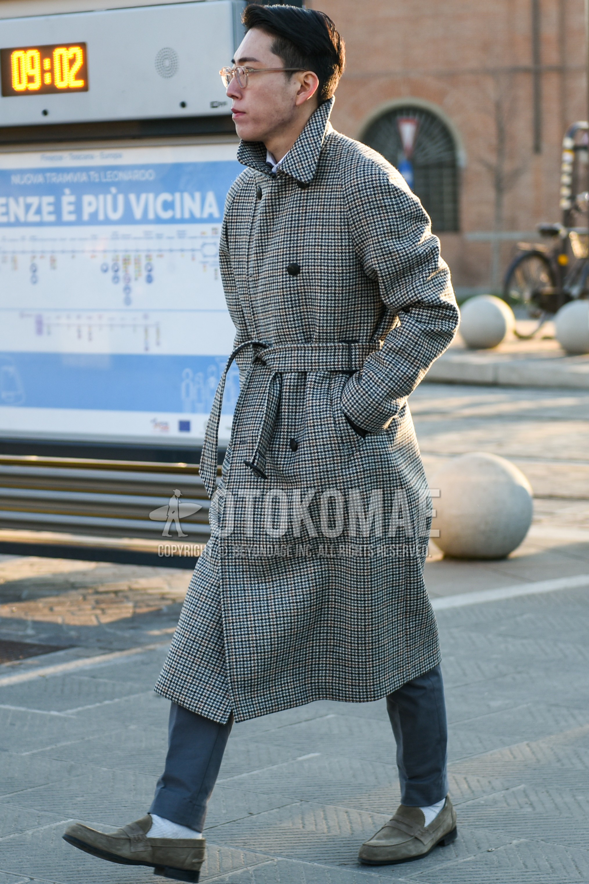 Men's autumn winter outfit with gray check trench coat, gray plain slacks, white plain socks, beige coin loafers leather shoes.