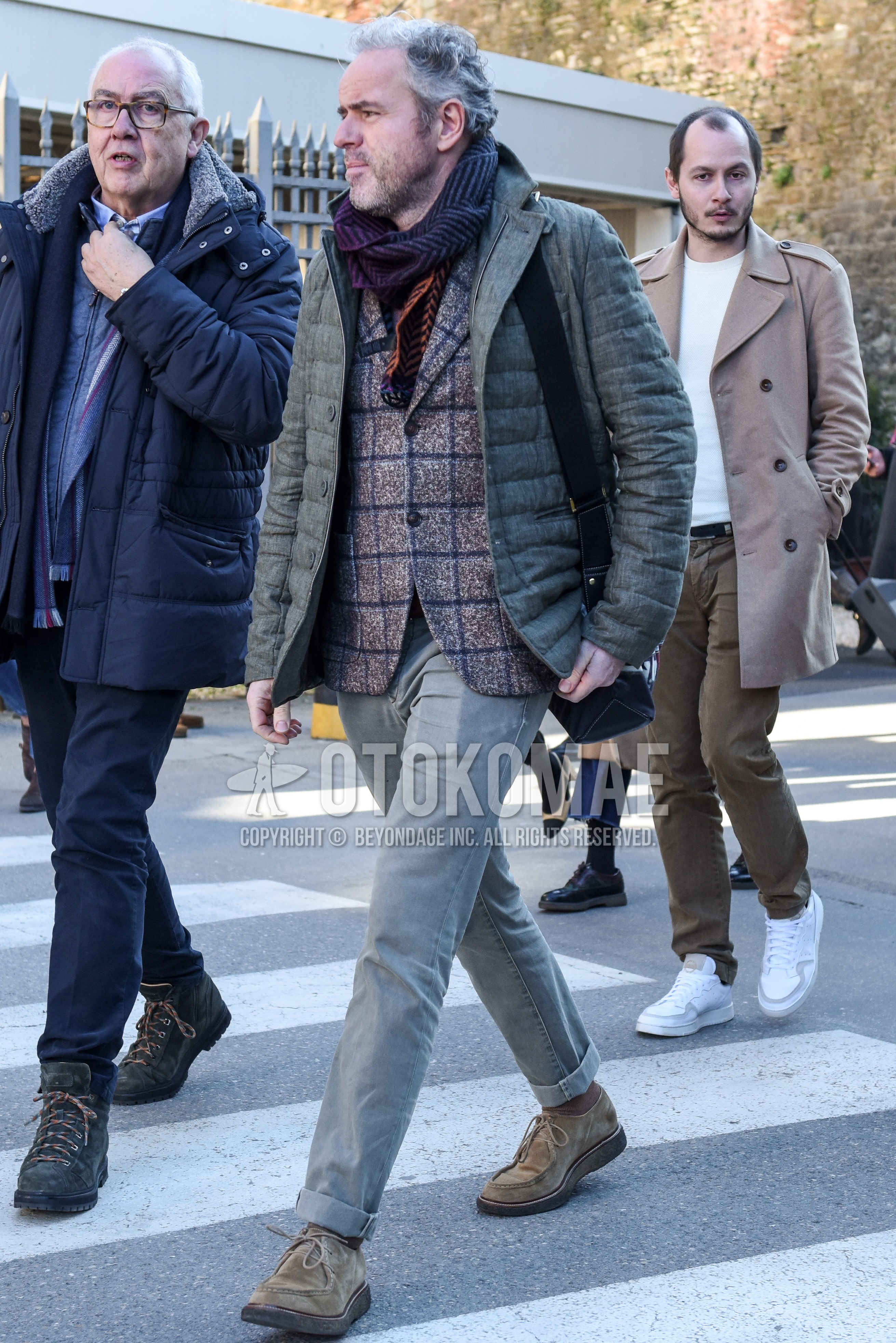 Men's autumn winter outfit with gray scarf scarf, gray plain quilted jacket, gray check tailored jacket, gray plain denim/jeans, beige plain socks, beige u-tip shoes leather shoes.