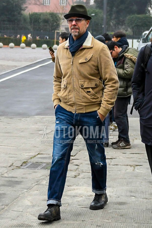 Men's autumn winter outfit with olive green plain hat, gray eyewear sunglasses, gray plain scarf, beige plain military jacket, blue plain damaged jeans, black straight-tip shoes leather shoes.