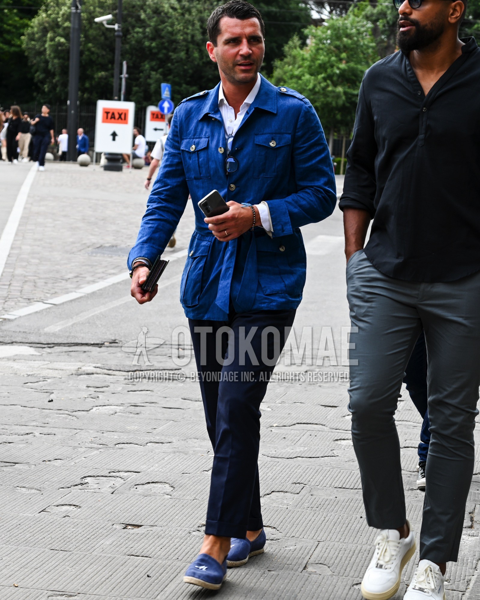 Men's spring summer autumn outfit with blue plain safari jacket, navy plain chinos, blue  loafers leather shoes.