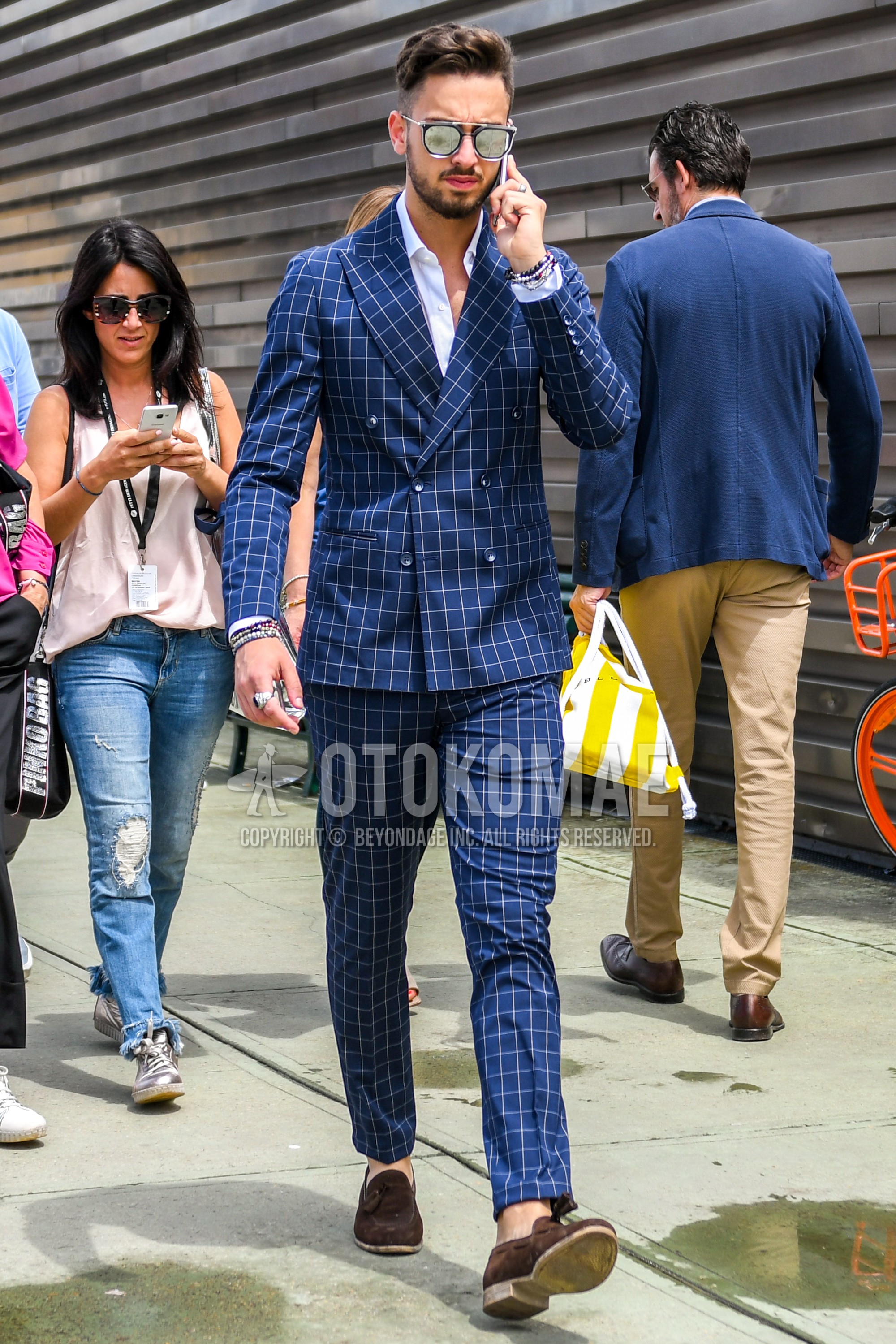 Men's spring summer autumn outfit with silver plain sunglasses, white plain shirt, brown tassel loafers leather shoes, blue check suit.