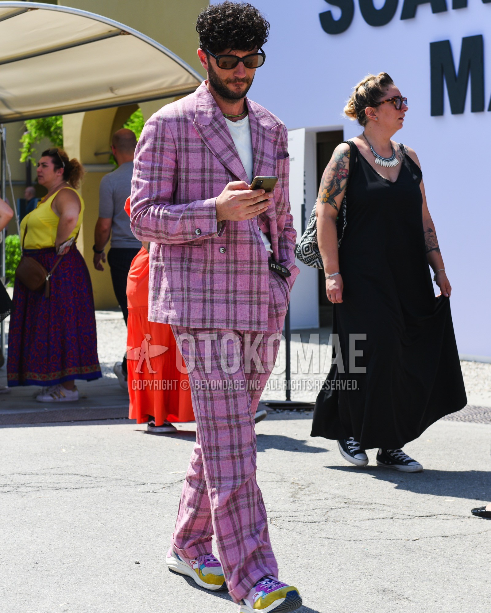 Men's spring summer outfit with black plain sunglasses, white plain t-shirt, black belt leather belt, pink purple yellow high-cut sneakers, pink check suit.