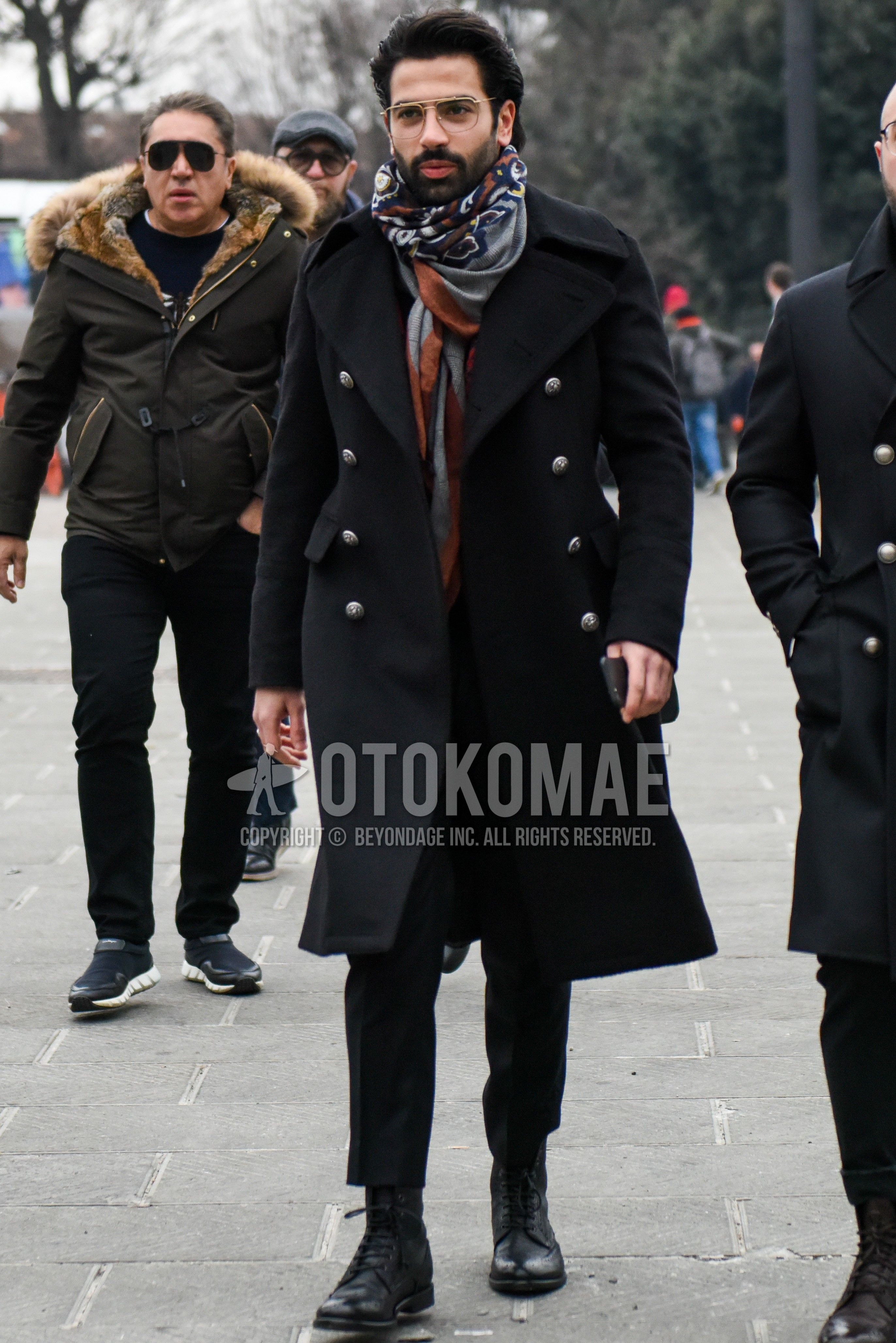 Men's winter outfit with gold plain glasses, multi-color scarf scarf, black plain ulster coat, black plain slacks, black country boots.
