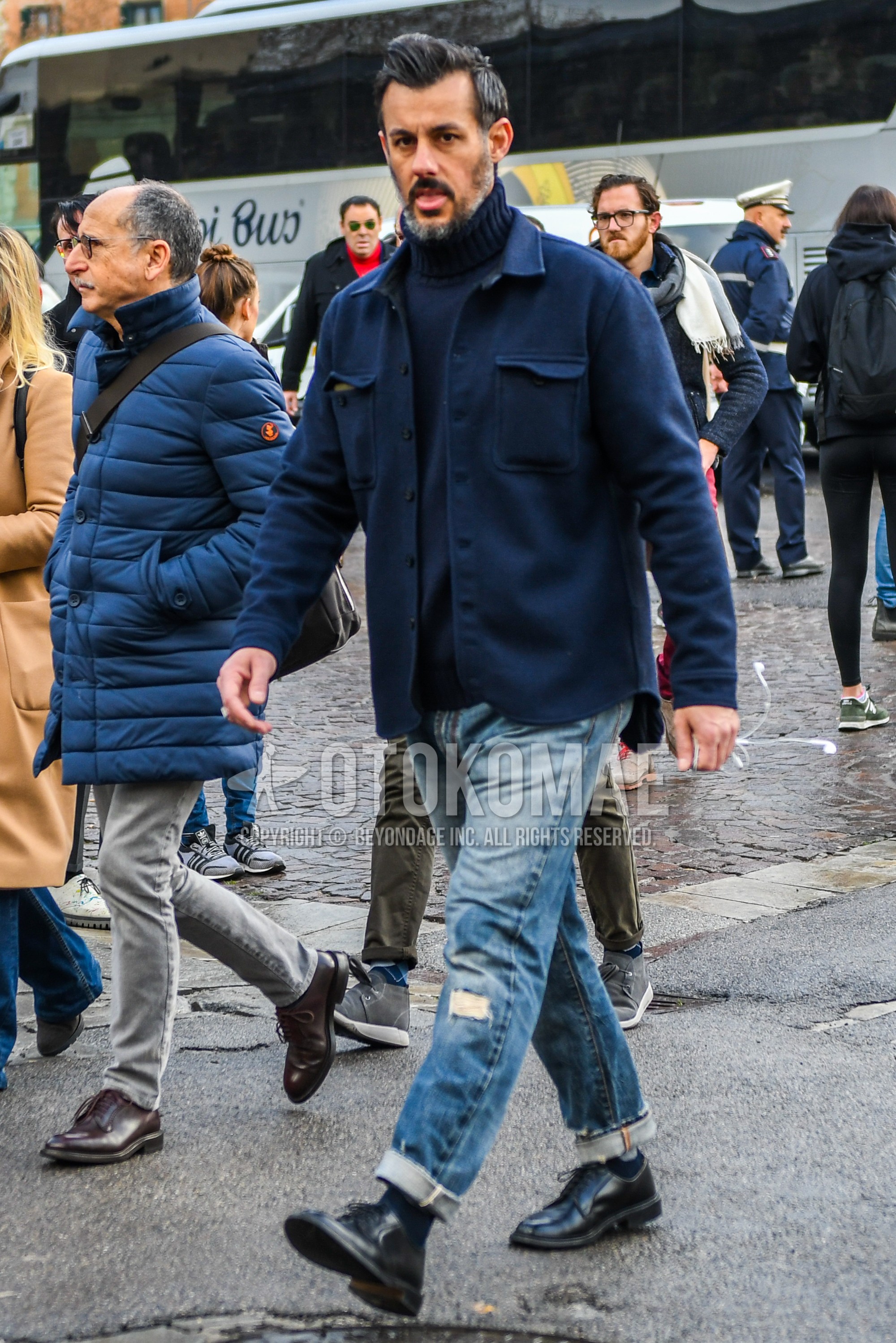 Men's winter outfit with navy plain shirt jacket, navy plain turtleneck knit, blue plain damaged jeans, navy plain socks, black plain toe leather shoes.