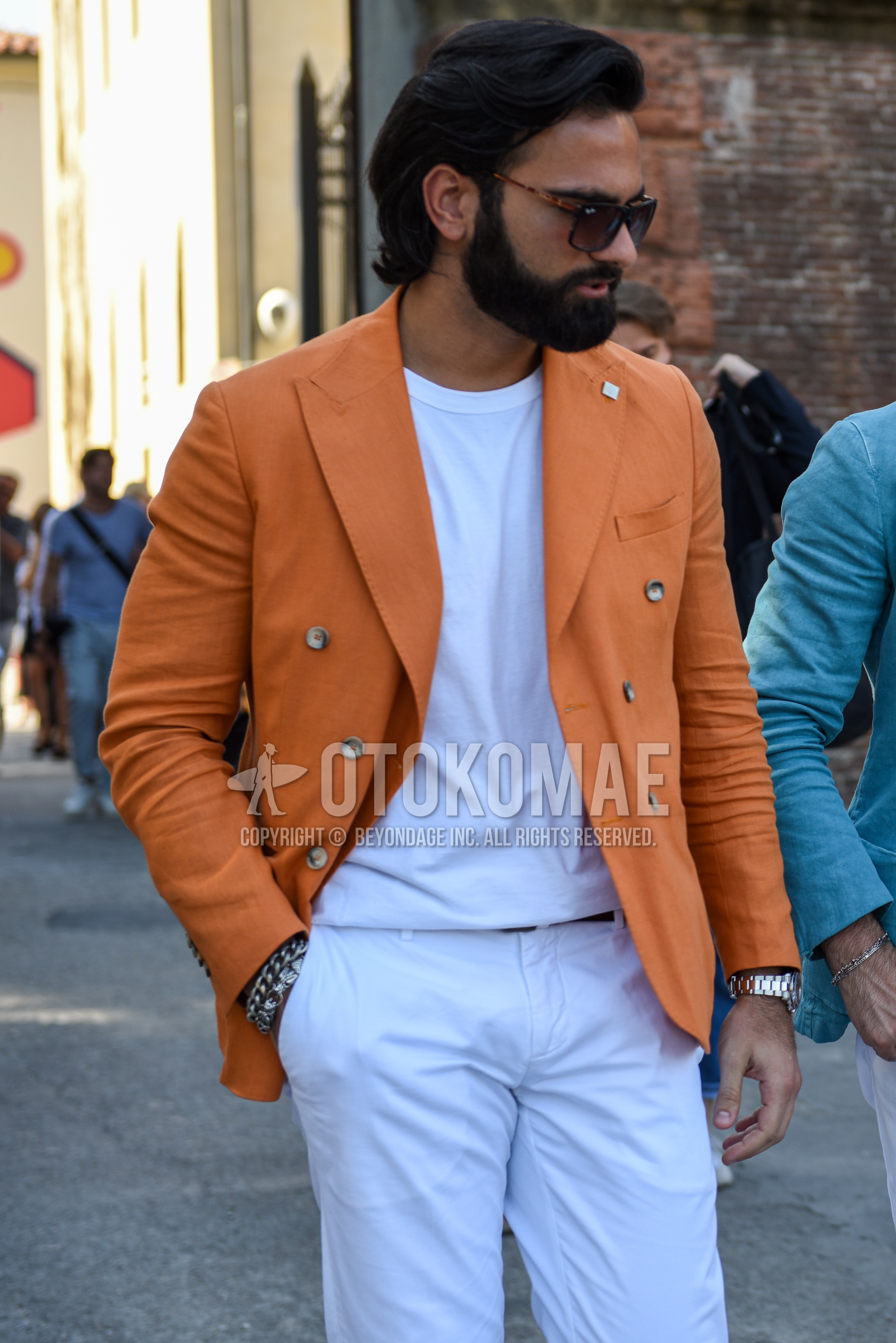 Men's spring summer autumn outfit with black plain sunglasses, orange plain tailored jacket, white plain t-shirt, white plain cotton pants.