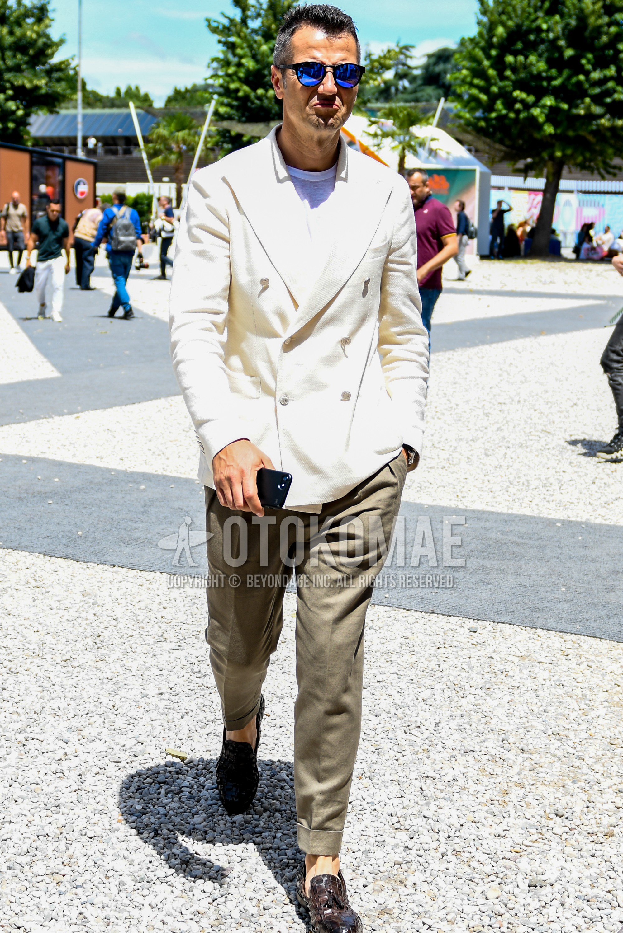 Men's spring summer autumn outfit with plain sunglasses, white plain tailored jacket, white plain t-shirt, beige plain slacks, brown tassel loafers leather shoes.