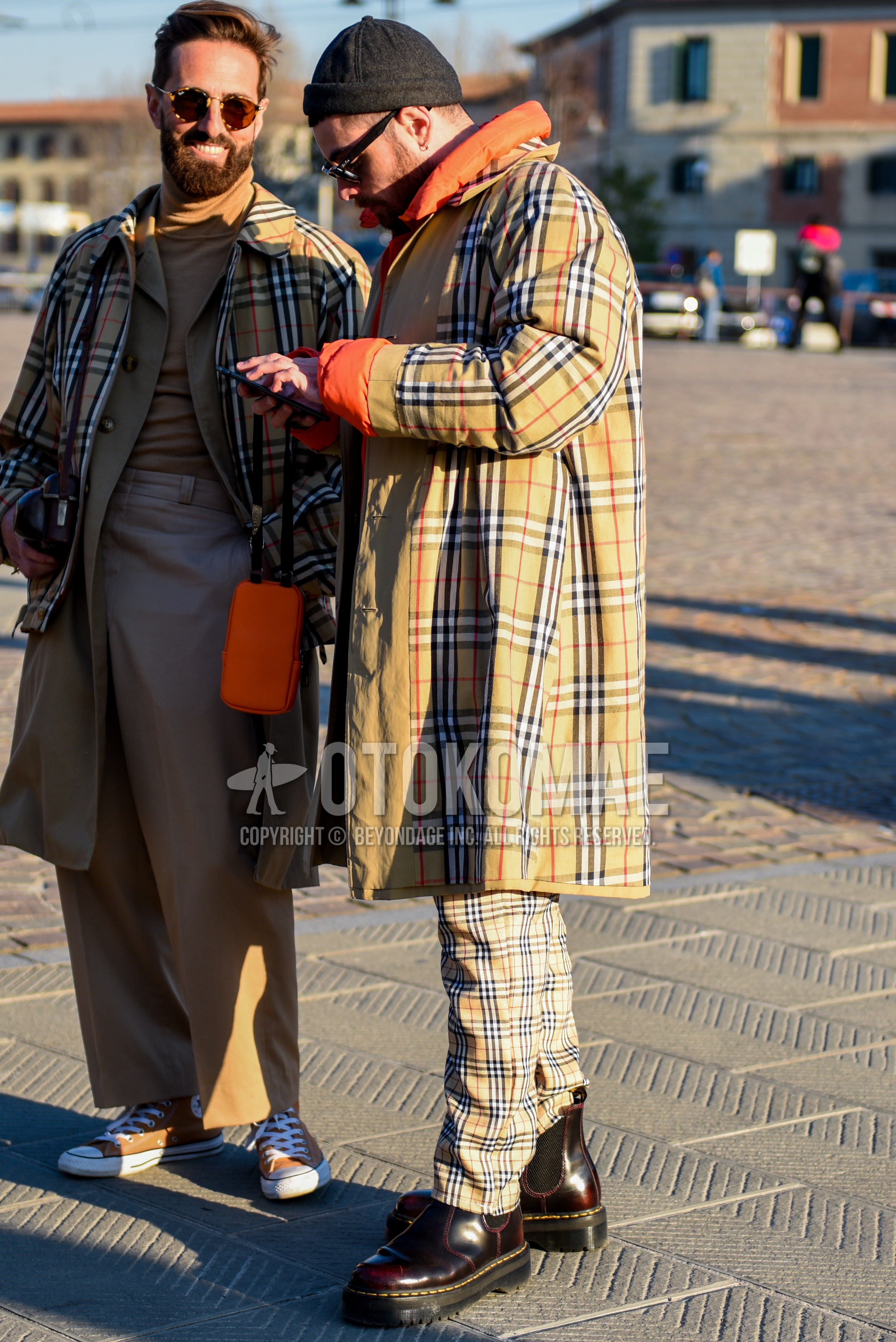Men's autumn winter outfit with black plain knit cap, black plain sunglasses, beige check stenkarrer coat, orange plain inner down, beige check slacks, brown side-gore boots.