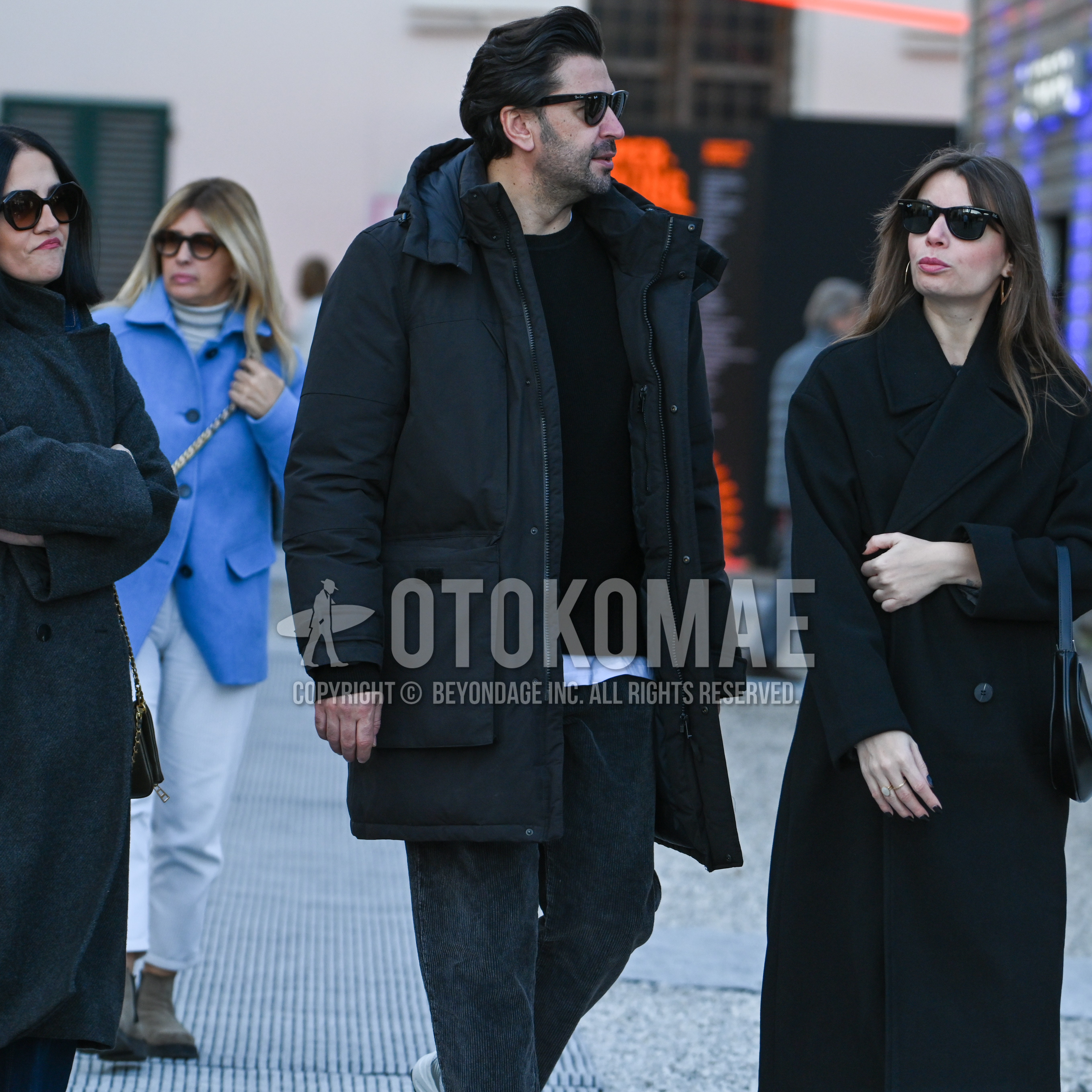 Men's autumn winter outfit with black plain sunglasses, black plain hooded coat, black plain sweater, white plain long sleeve t-shirt, dark gray plain winter pants (corduroy,velour).