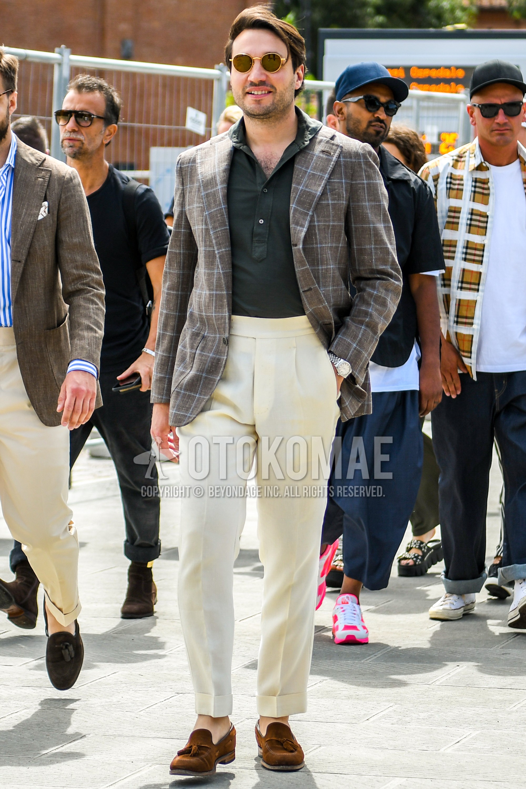 Men's spring summer autumn outfit with yellow black plain sunglasses, beige check tailored jacket, black plain shirt, beige plain slacks, beige plain beltless pants, brown tassel loafers leather shoes.
