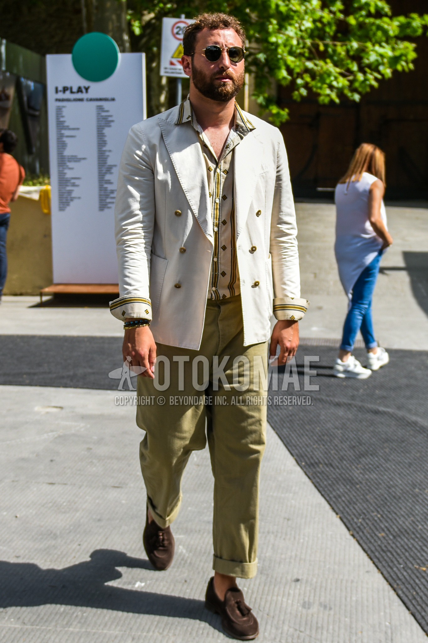 Men's spring summer autumn outfit with gold plain sunglasses, white plain tailored jacket, yellow white tops/innerwear shirt, beige plain wide pants, brown tassel loafers leather shoes.