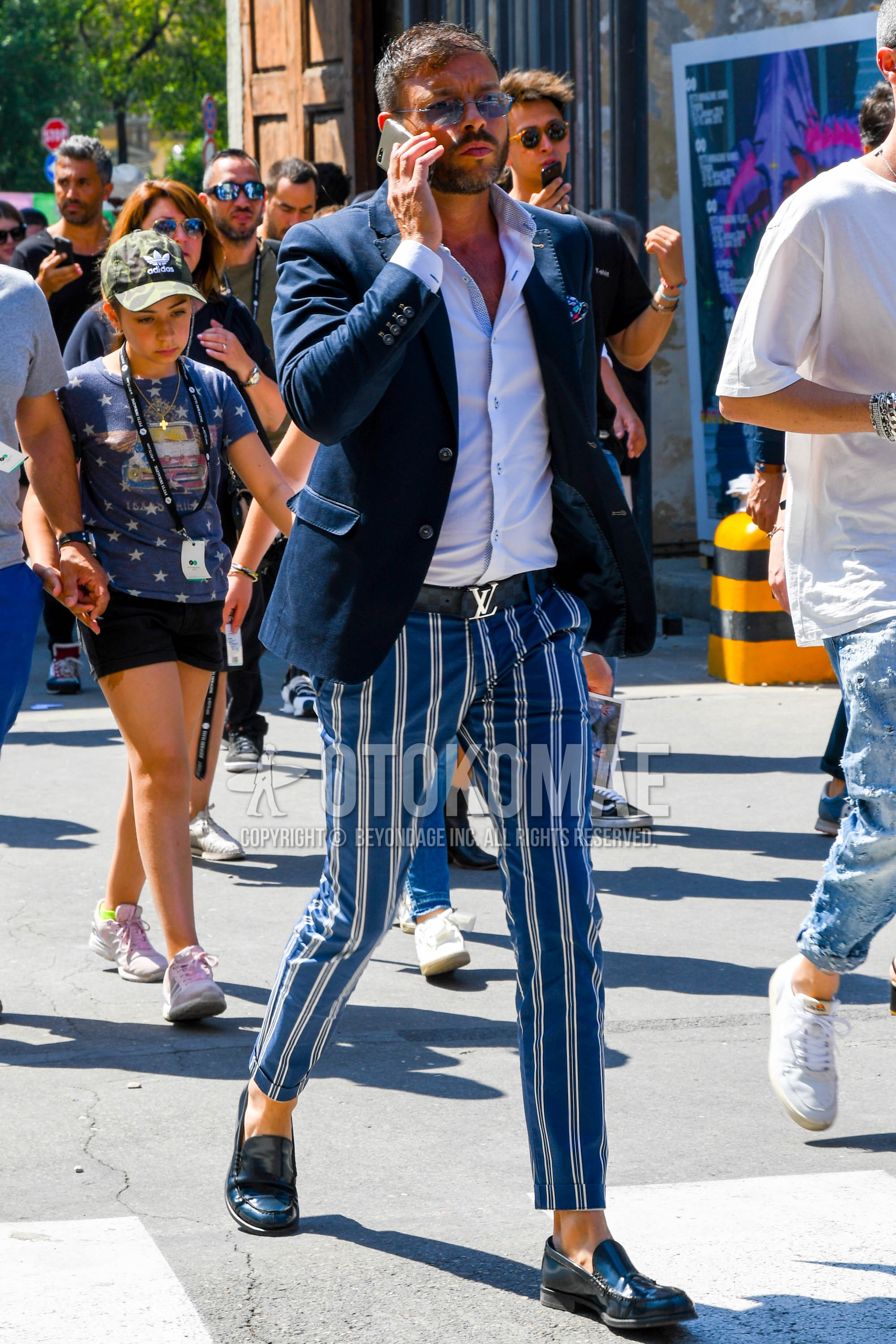 Men's spring summer autumn outfit with plain sunglasses, plain tailored jacket, white plain shirt, navy plain leather belt, blue stripes cotton pants, blue coin loafers leather shoes.