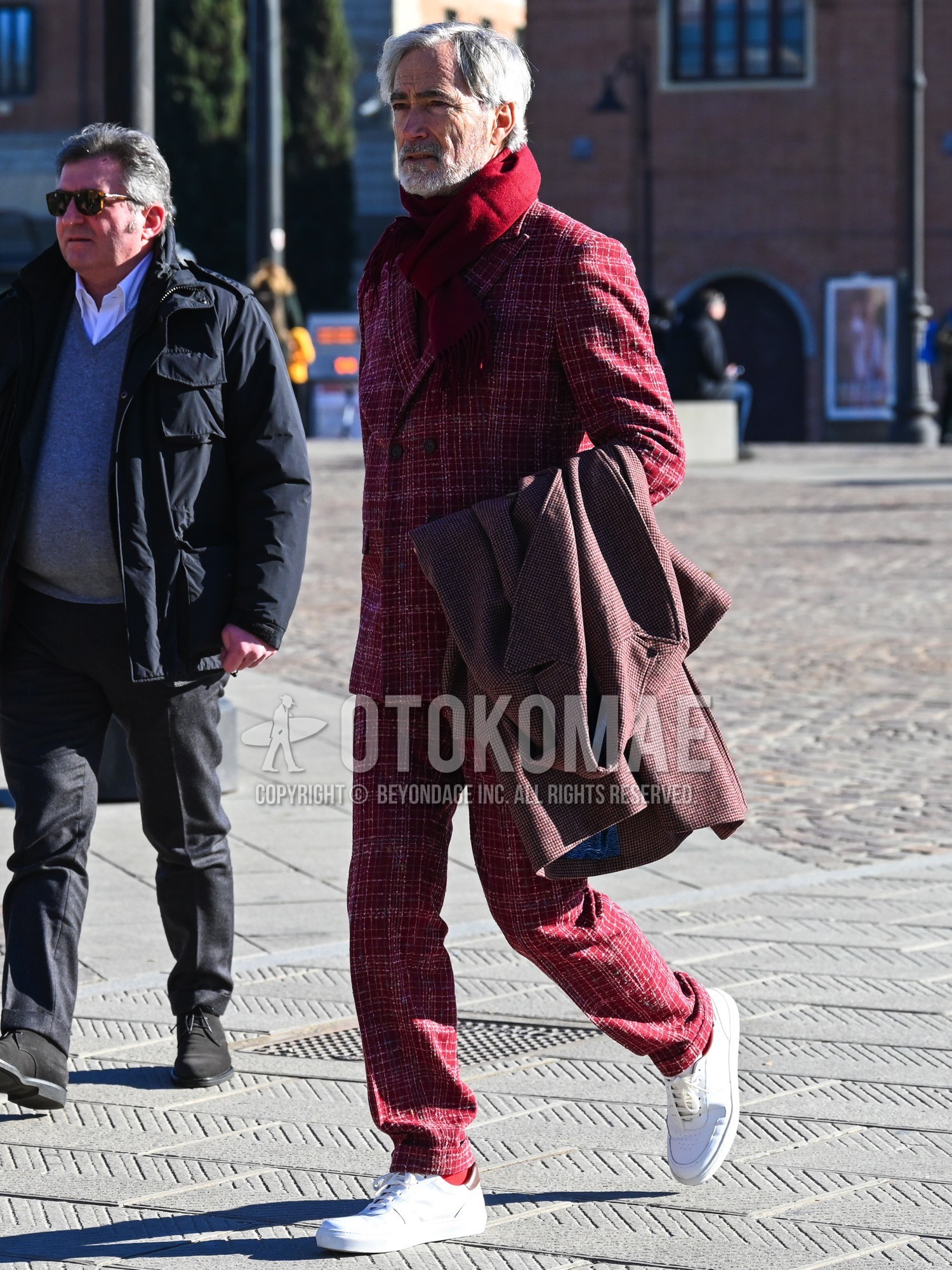 Men's autumn winter outfit with red plain scarf, red check chester coat, red plain socks, white low-cut sneakers, red check suit.