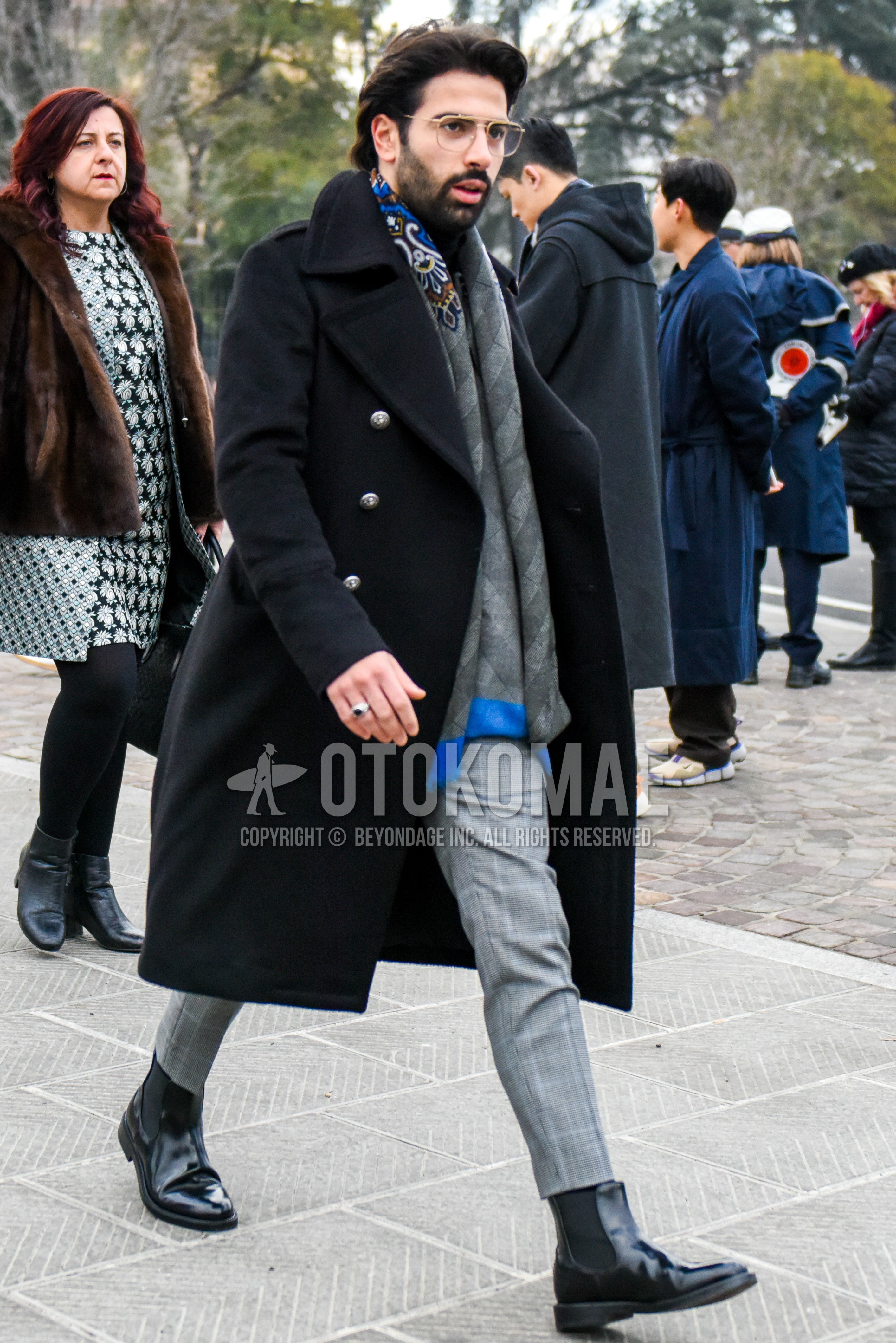 Men's winter outfit with gold plain glasses, gray scarf scarf, black plain ulster coat, gray check slacks, black side-gore boots.
