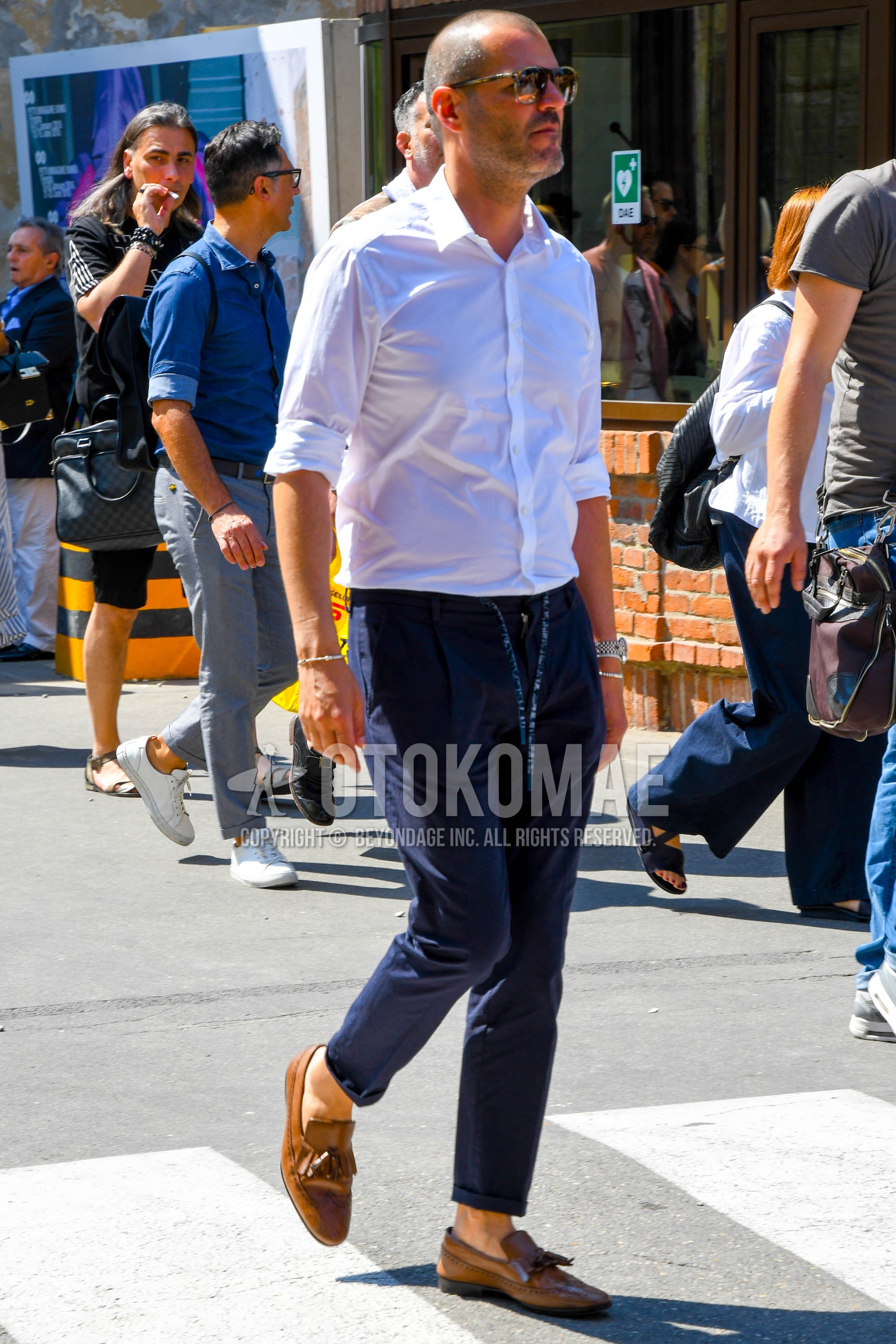Men's spring summer autumn outfit with plain sunglasses, white plain shirt, navy plain easy pants, brown tassel loafers leather shoes.
