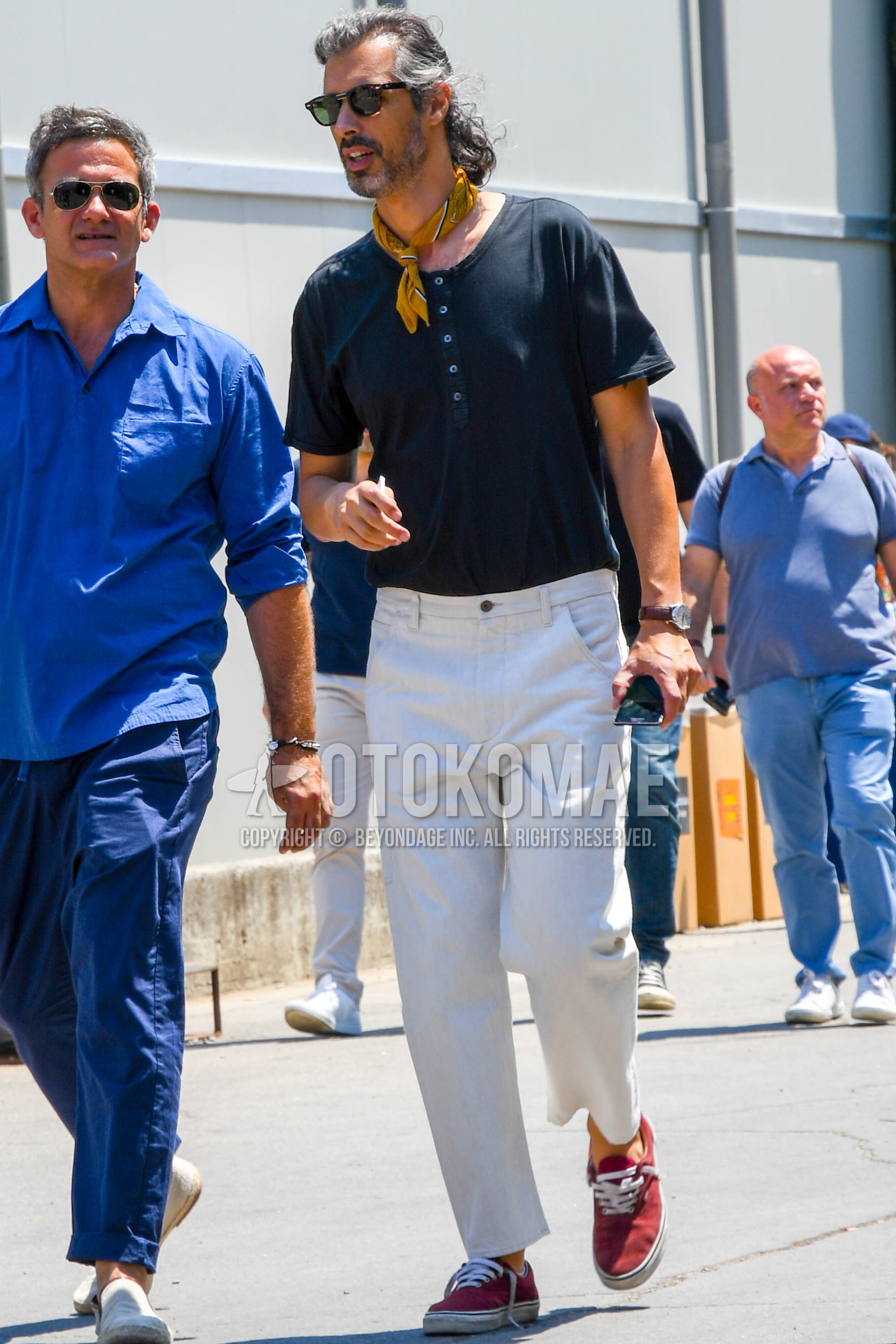 Men's summer outfit with plain sunglasses, yellow plain bandana/neckerchief, black plain t-shirt, white plain wide pants, red low-cut sneakers.