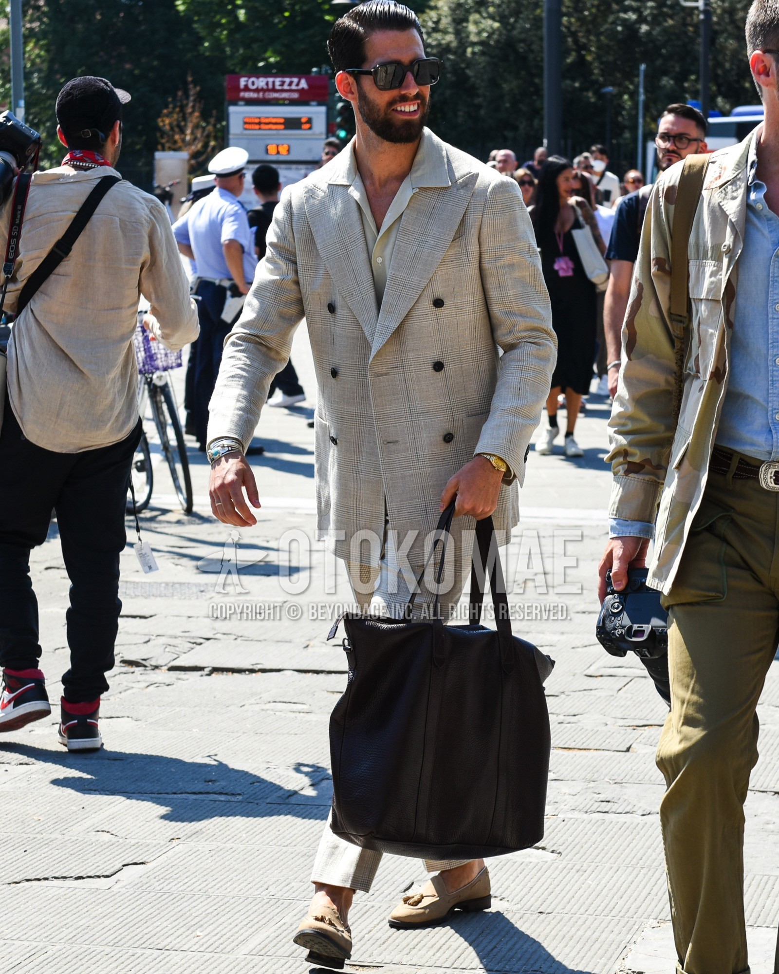 Men's spring summer outfit with black plain sunglasses, beige plain shirt, beige tassel loafers leather shoes, brown plain briefcase/handbag, gray check suit.