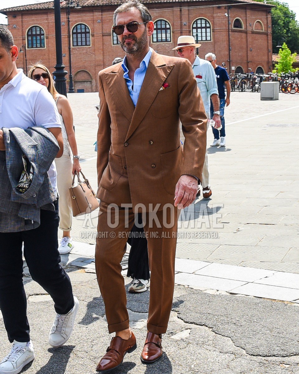Men's spring summer outfit with brown tortoiseshell sunglasses, blue plain shirt, brown monk shoes leather shoes, brown plain suit.